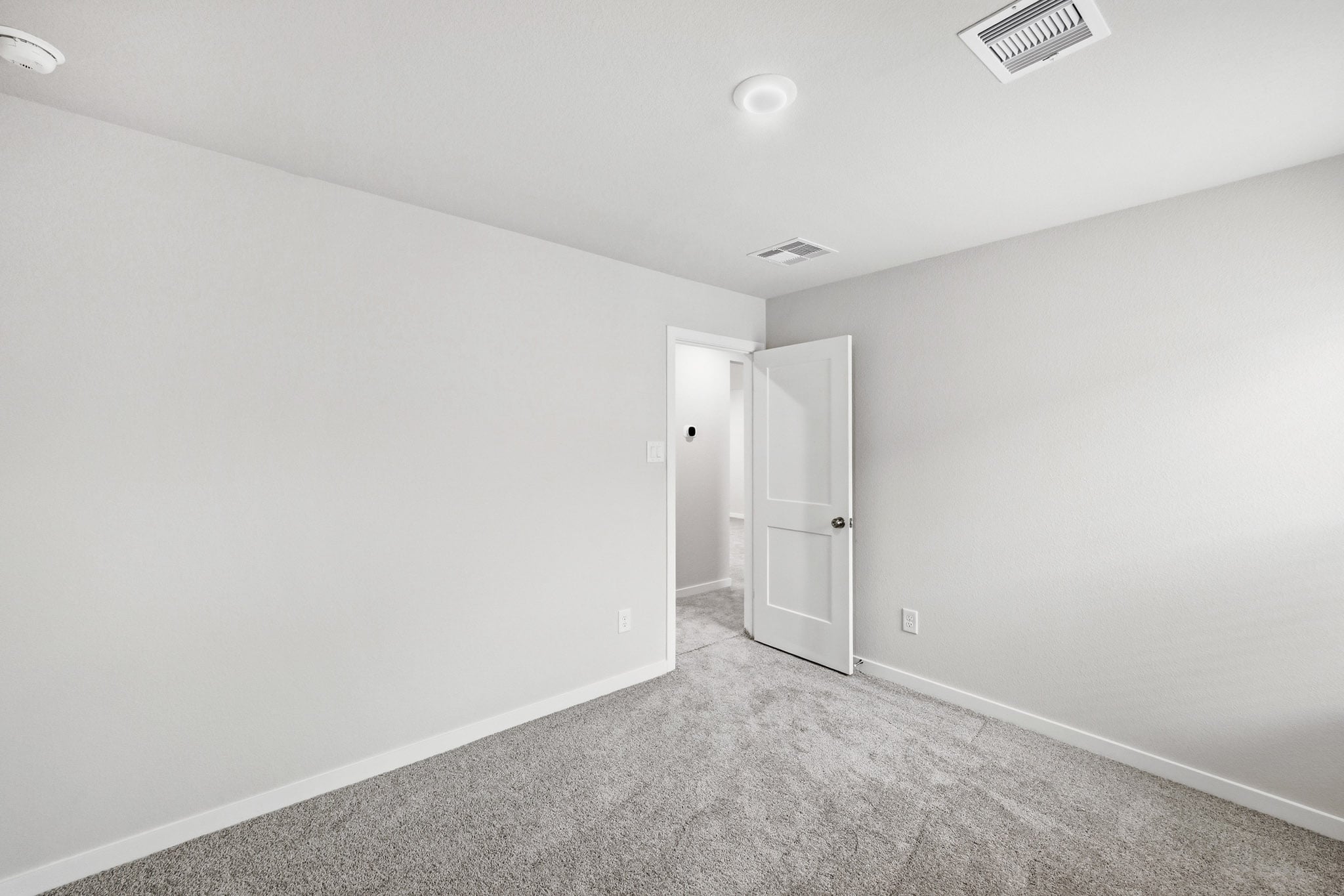 A hallway with white walls.
