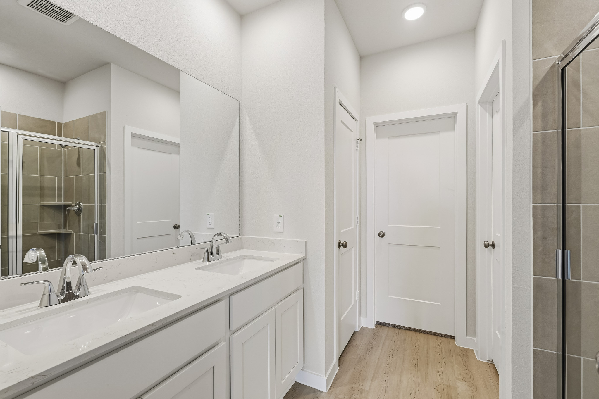 A bathroom with a large mirror.