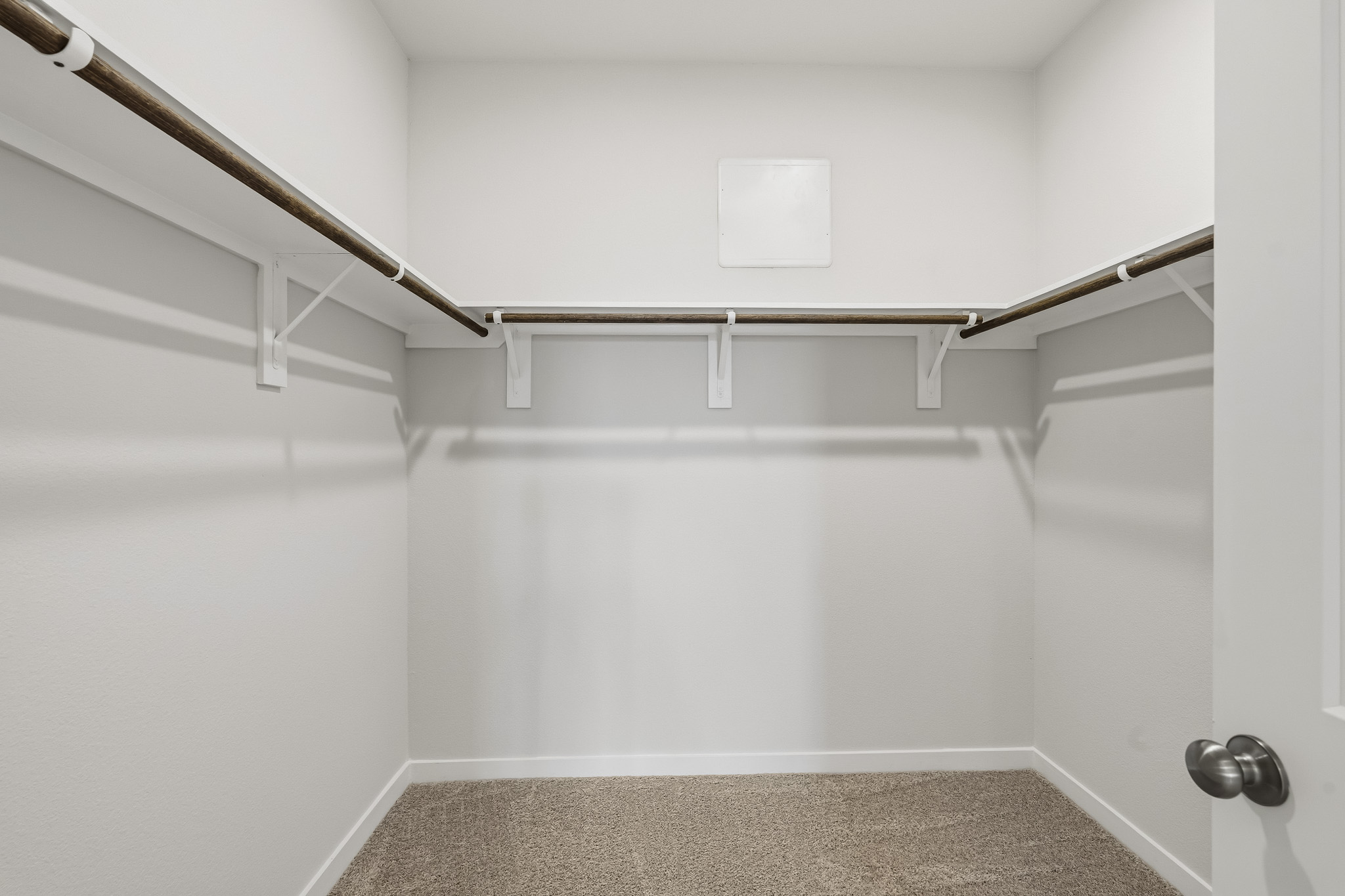 A white wall with a metal railing.
