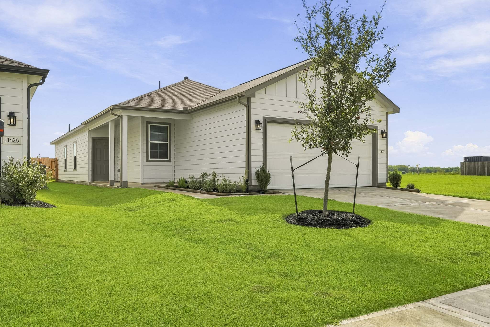 A house with a tree in the front yard.