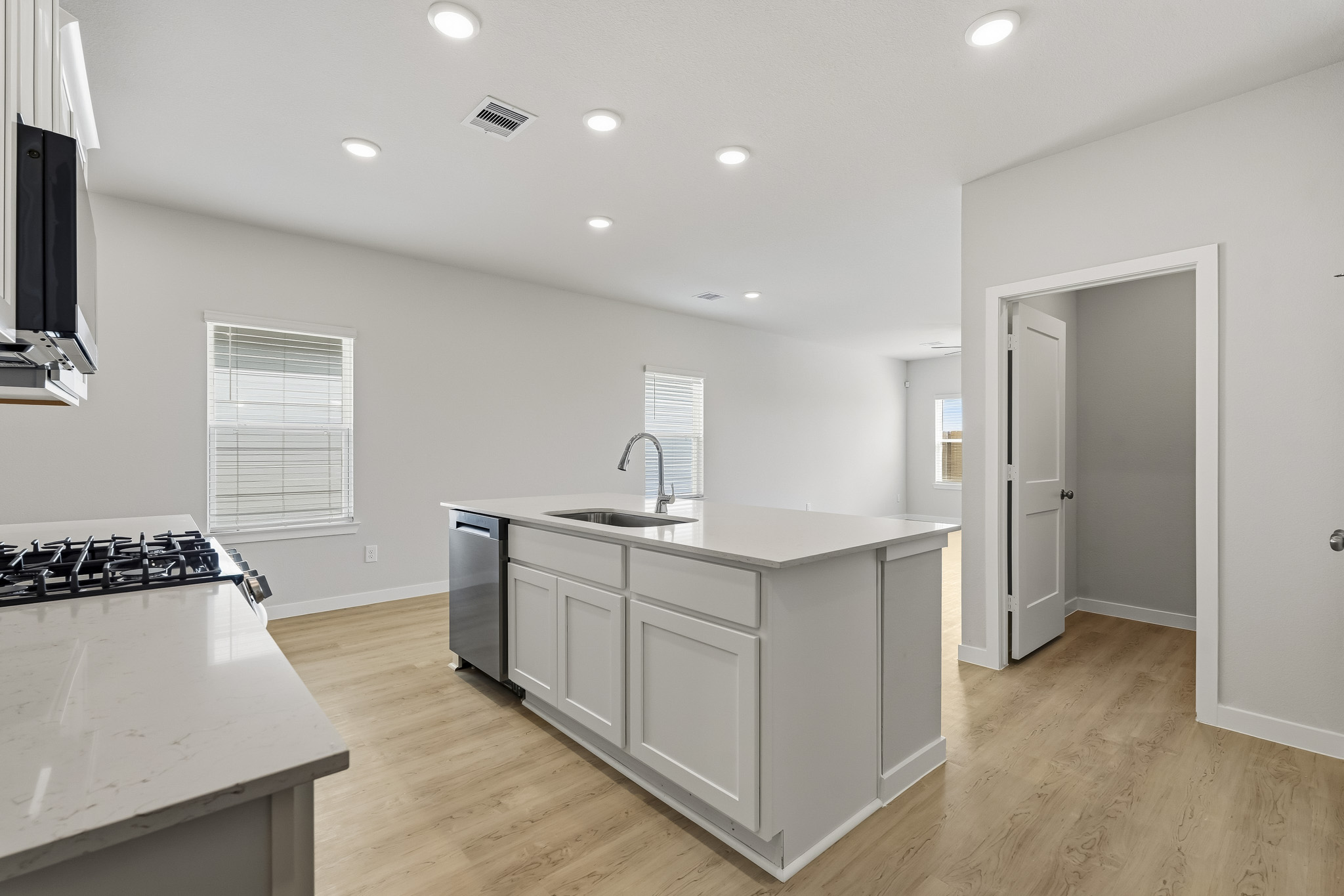 A kitchen with white cabinets.