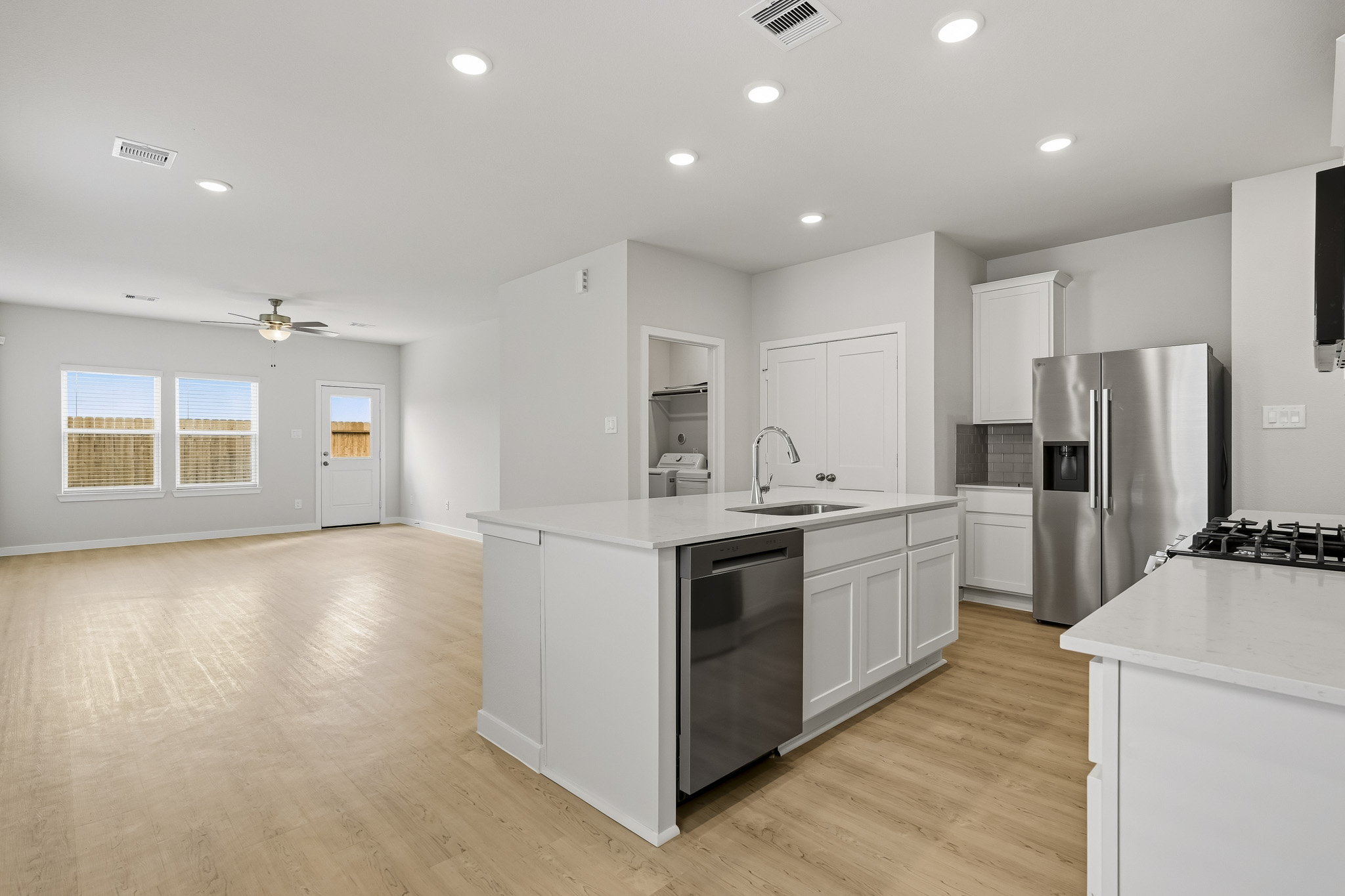 A kitchen with white cabinets.