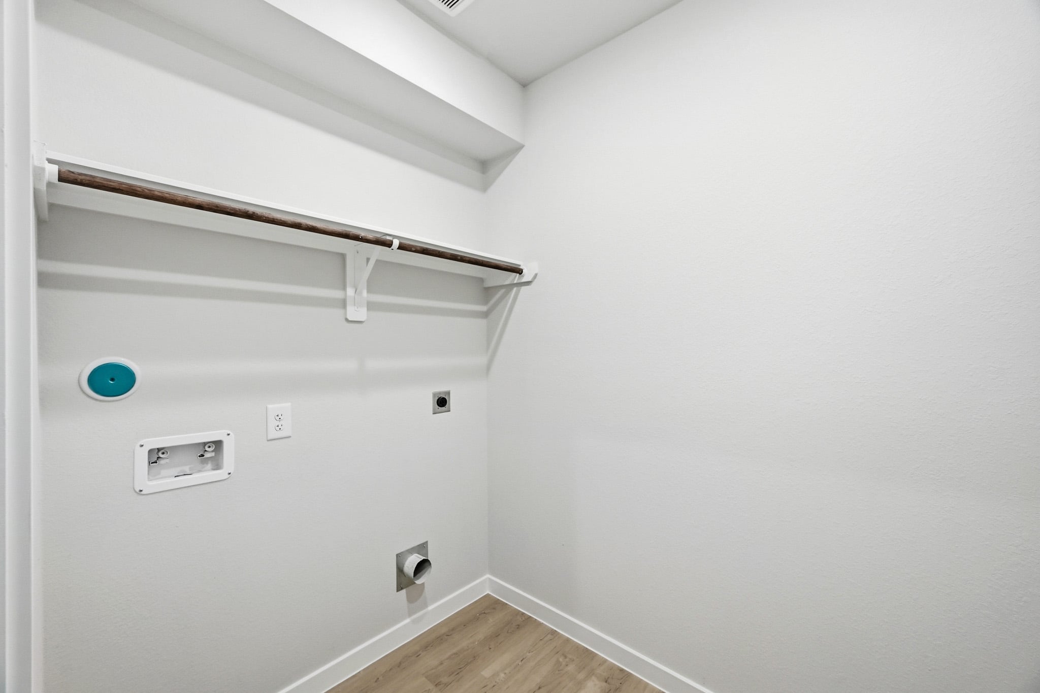 A white wall with a light fixture.