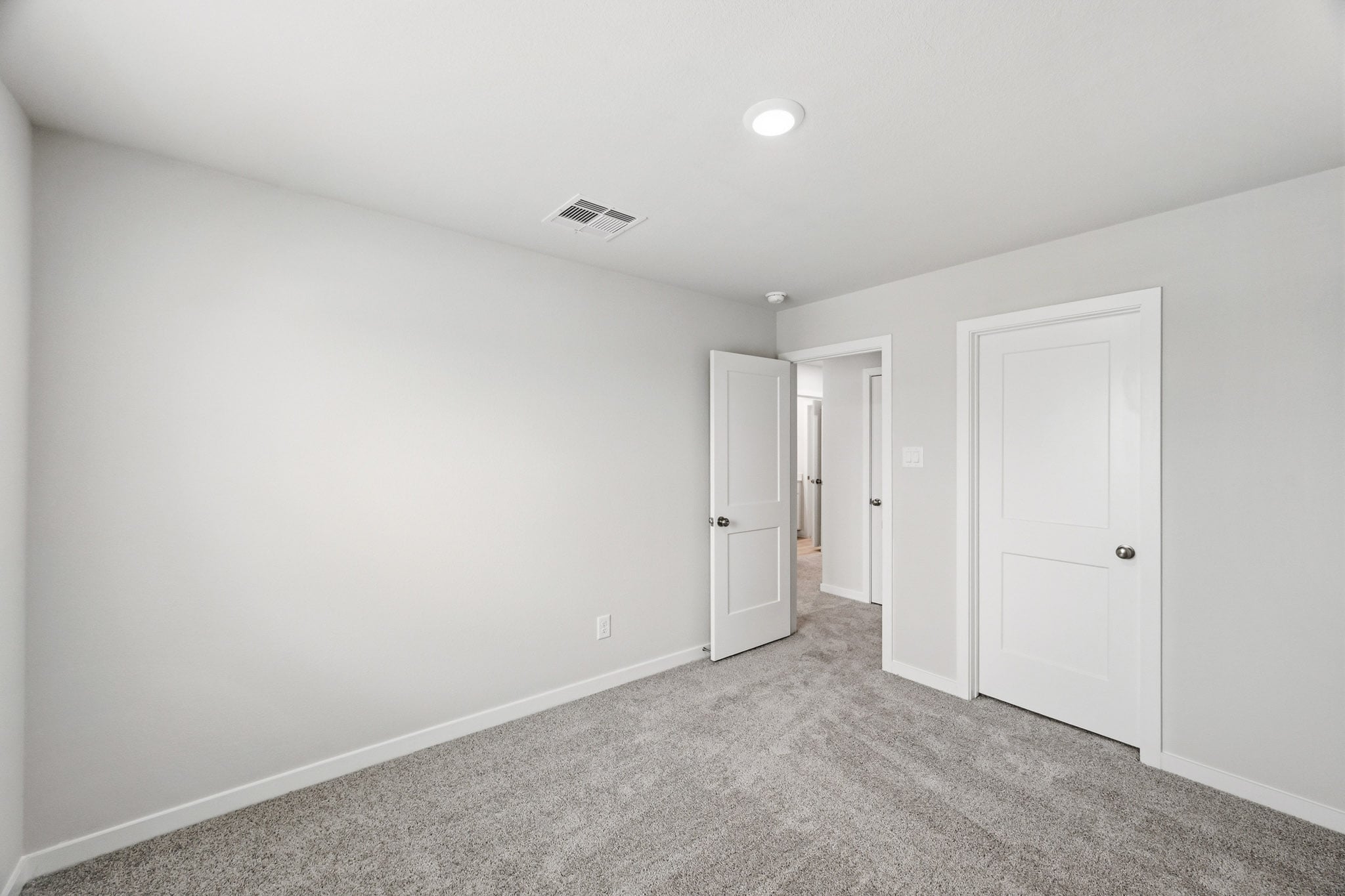 A hallway with white doors.