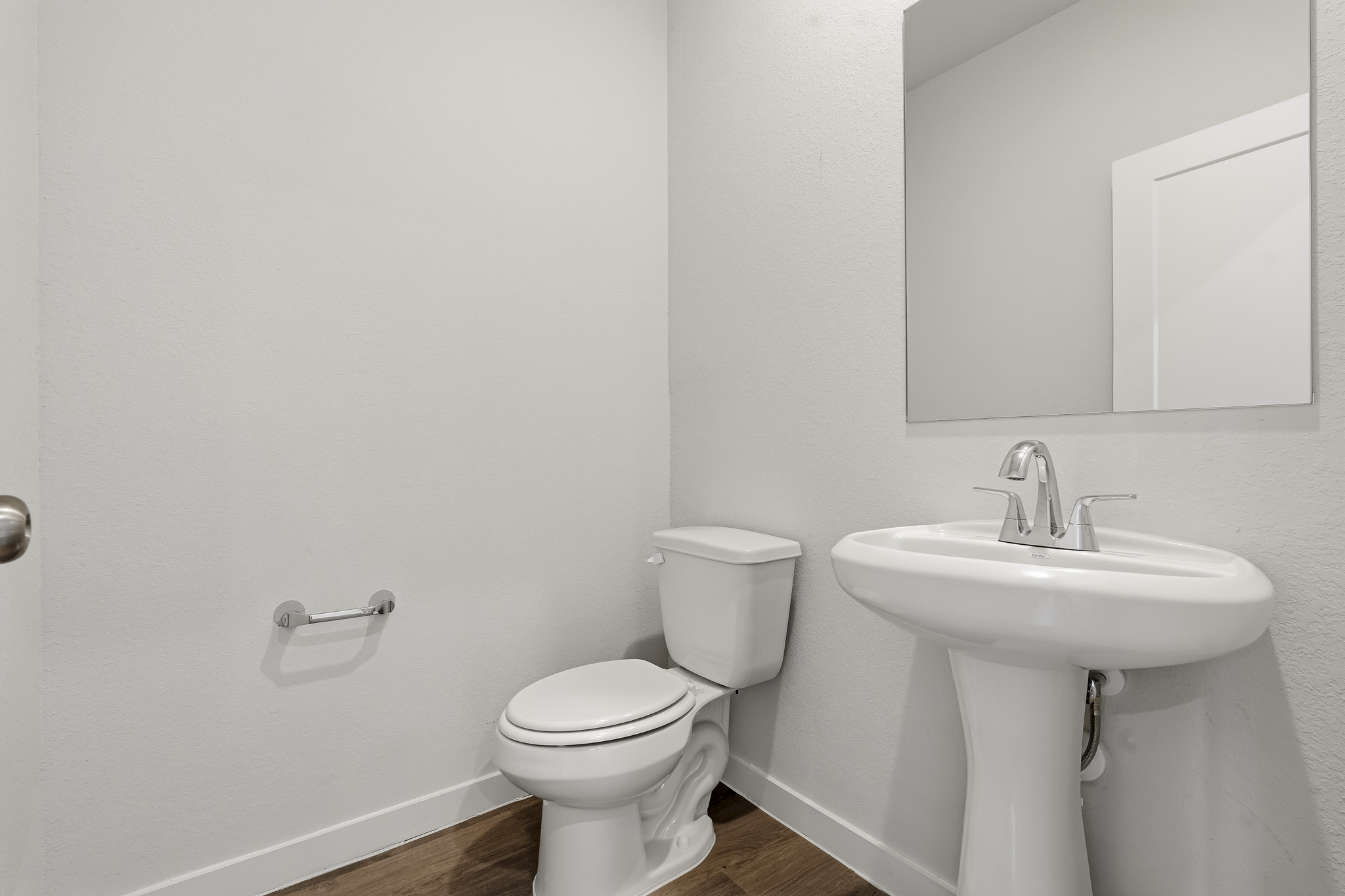 A bathroom with a toilet and sink.