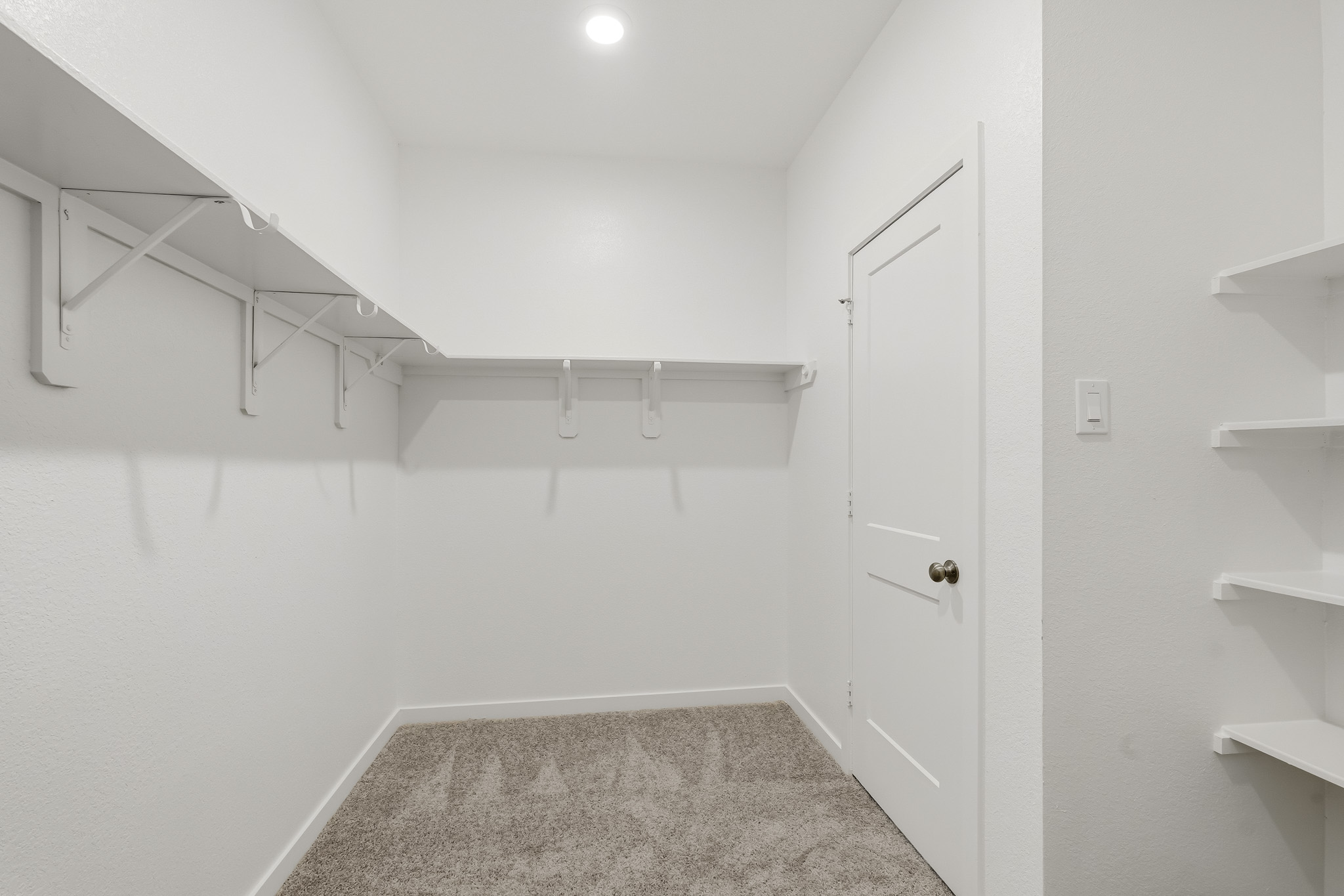 A white room with a staircase.
