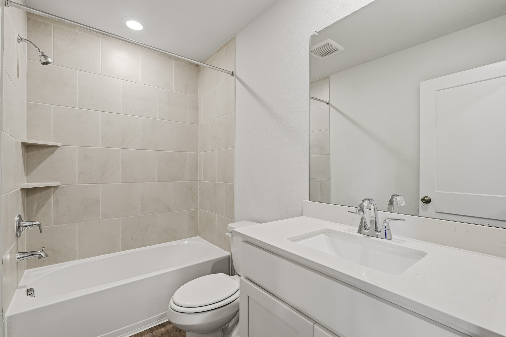 A bathroom with a tub sink and toilet.