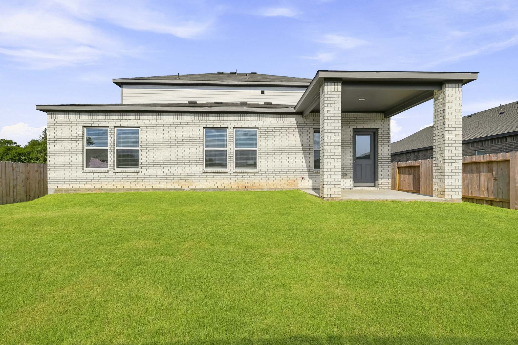 A house with a grass yard.