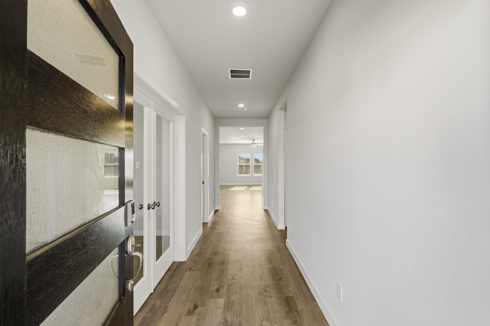 A hallway with white doors.