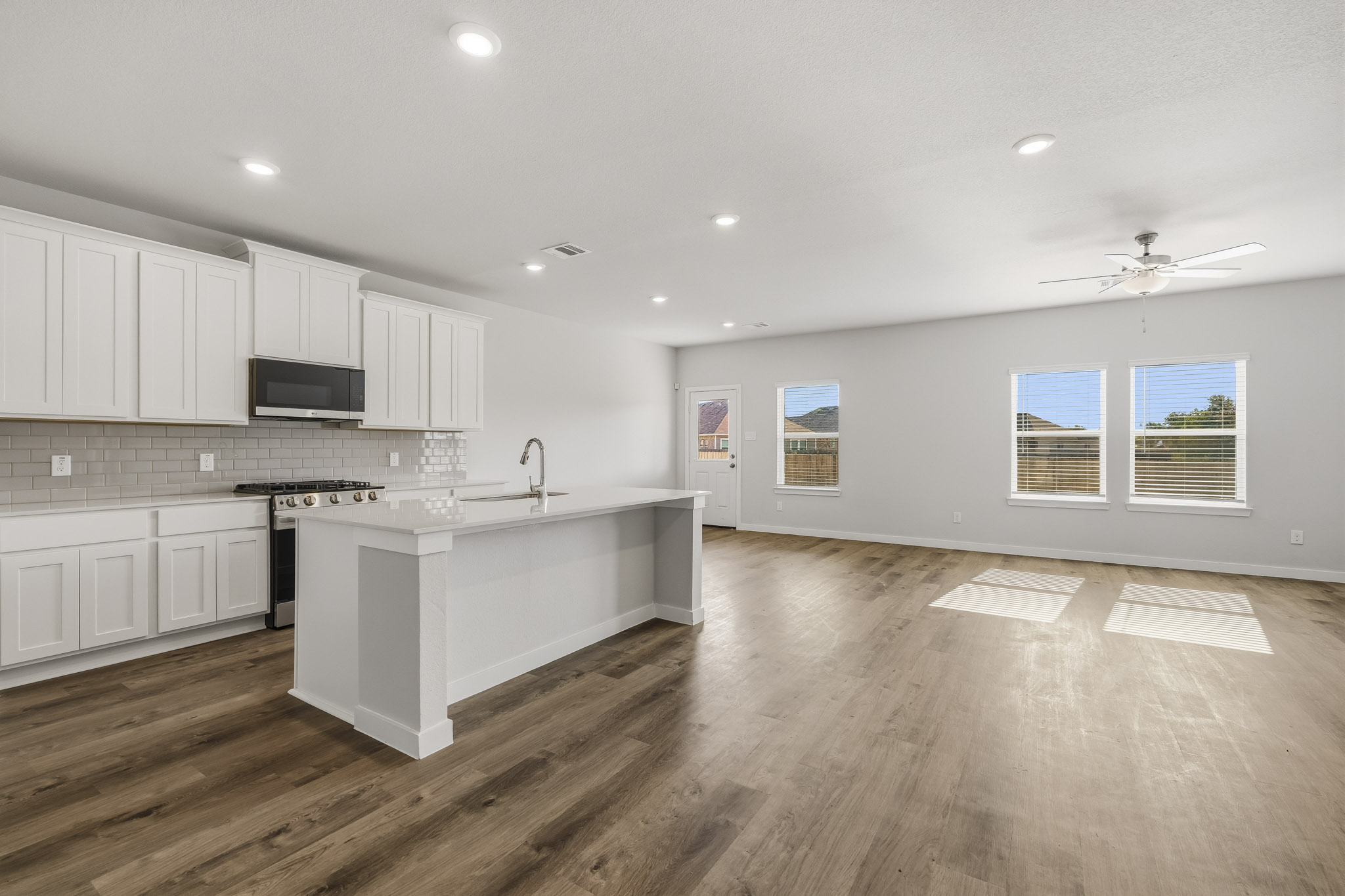 A kitchen with white cabinets.