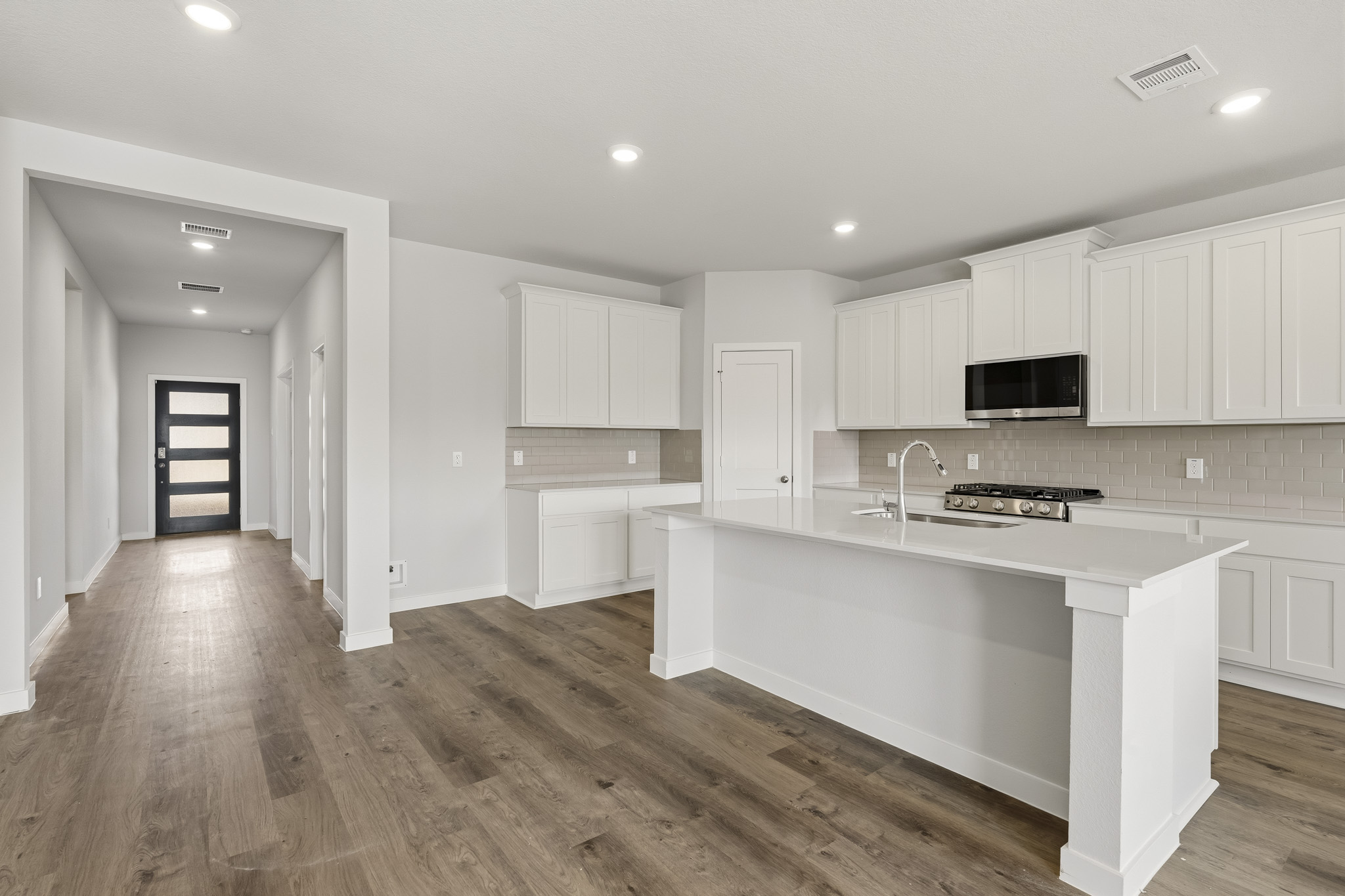 A kitchen with white cabinets.