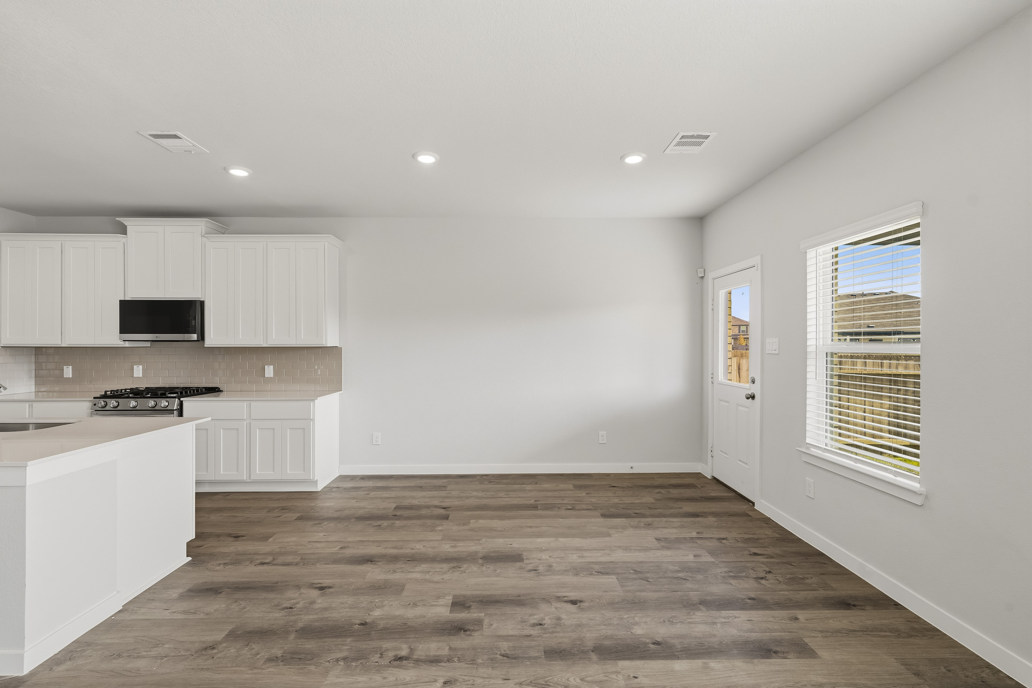 A kitchen with white cabinets.