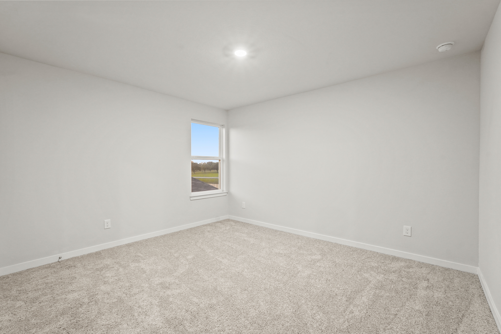 A room with a window and carpet.