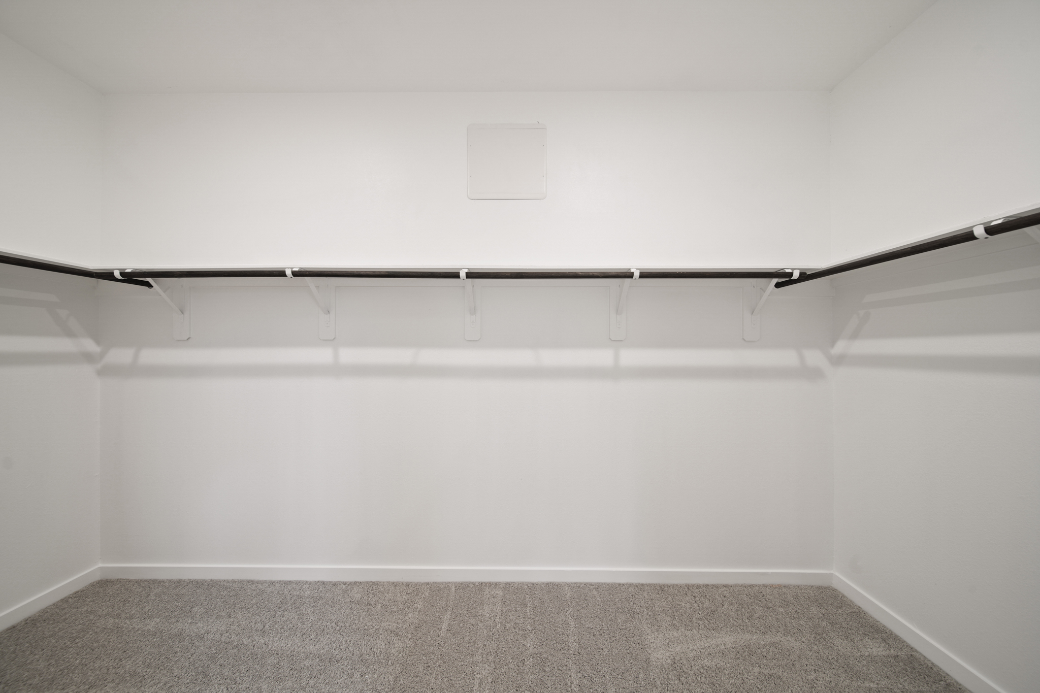 A white wall with a black floor.