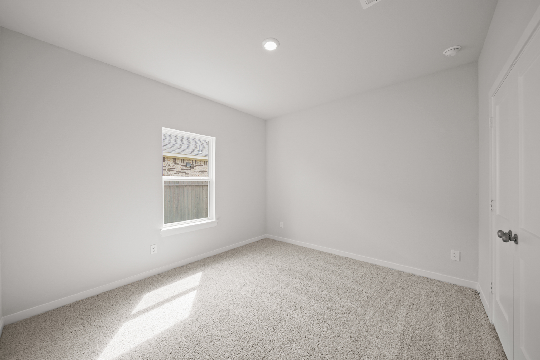 A room with a door and a window.