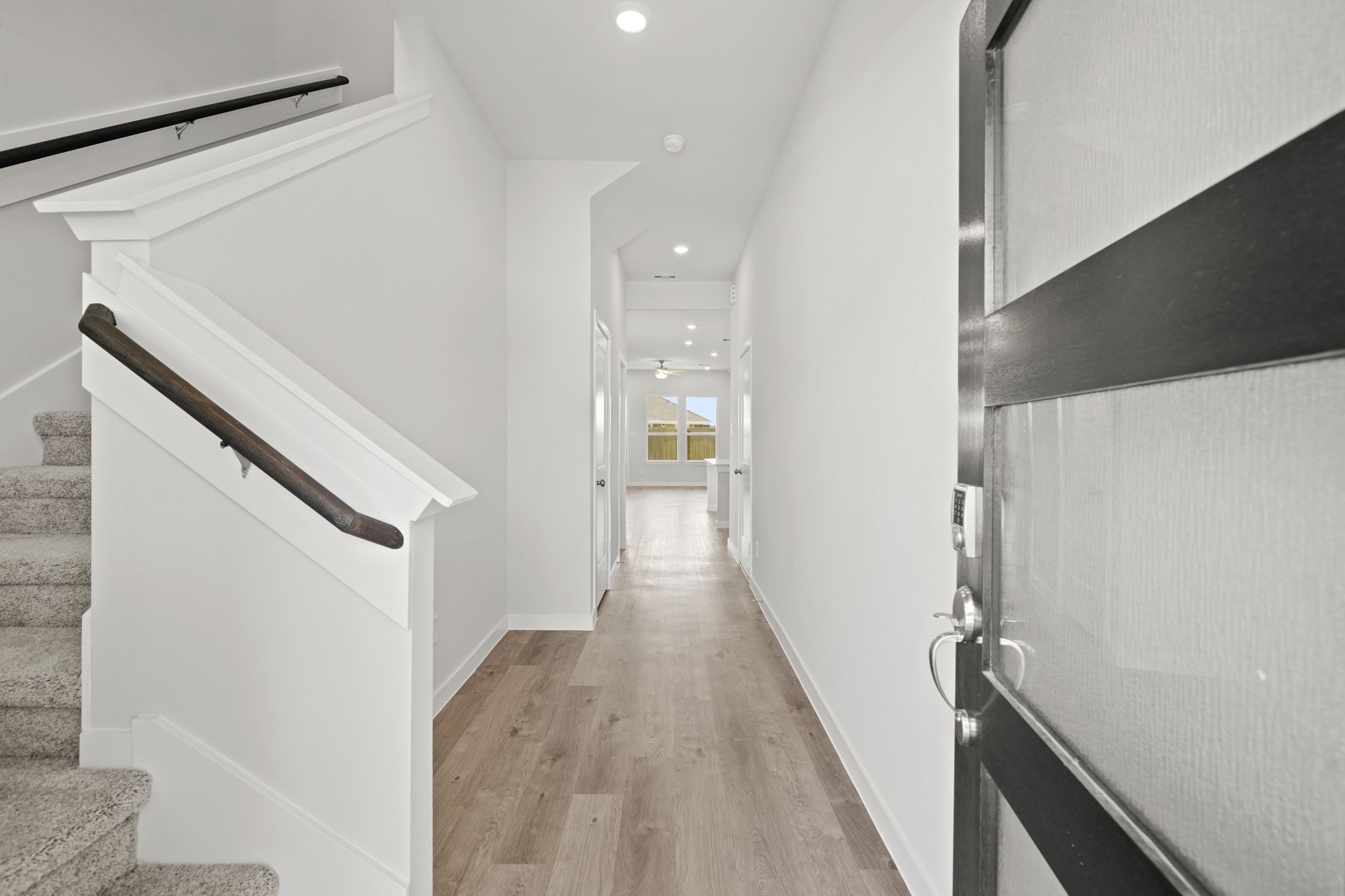A hallway with white walls.