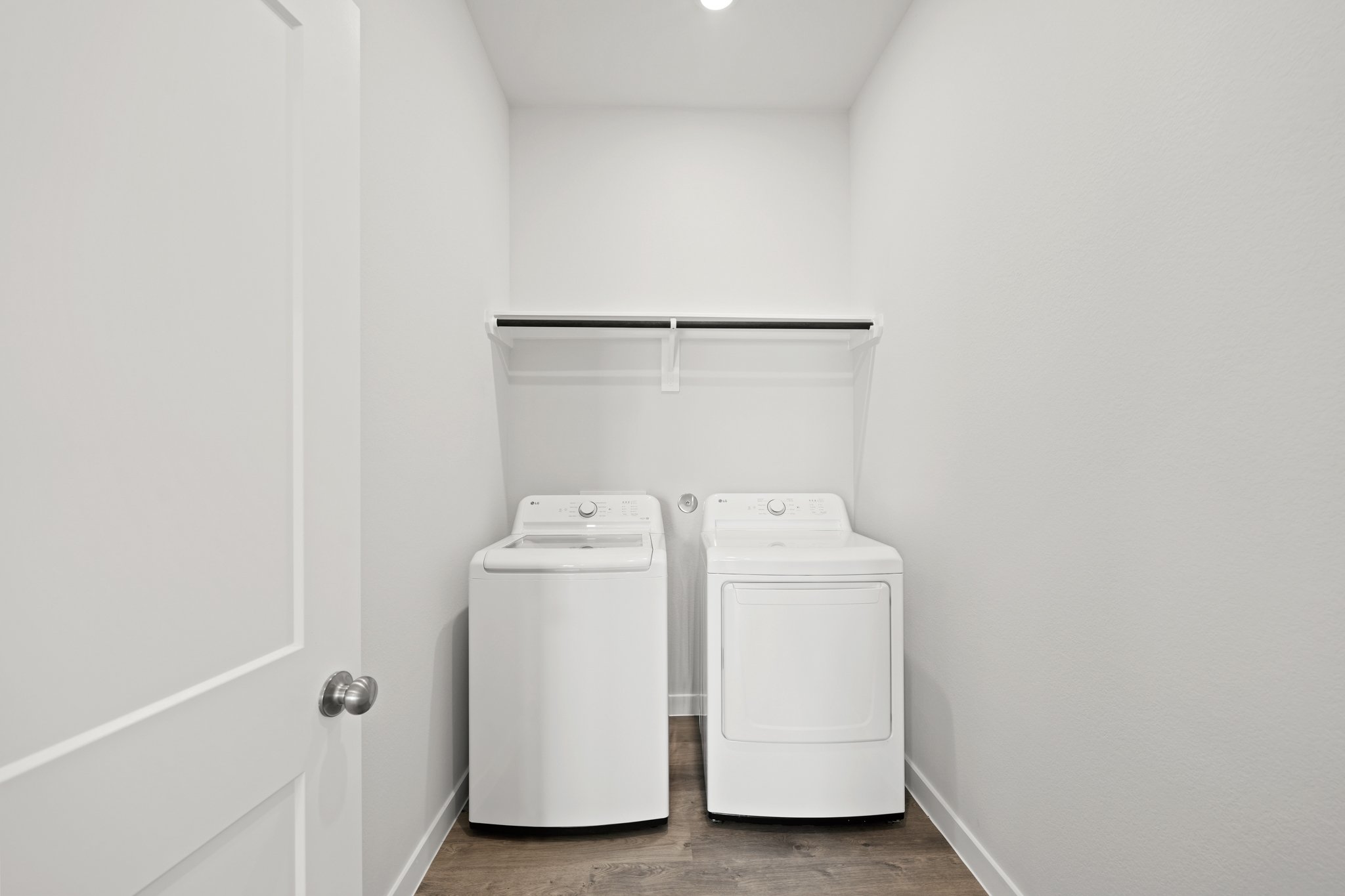 A white room with a washer and dryer.