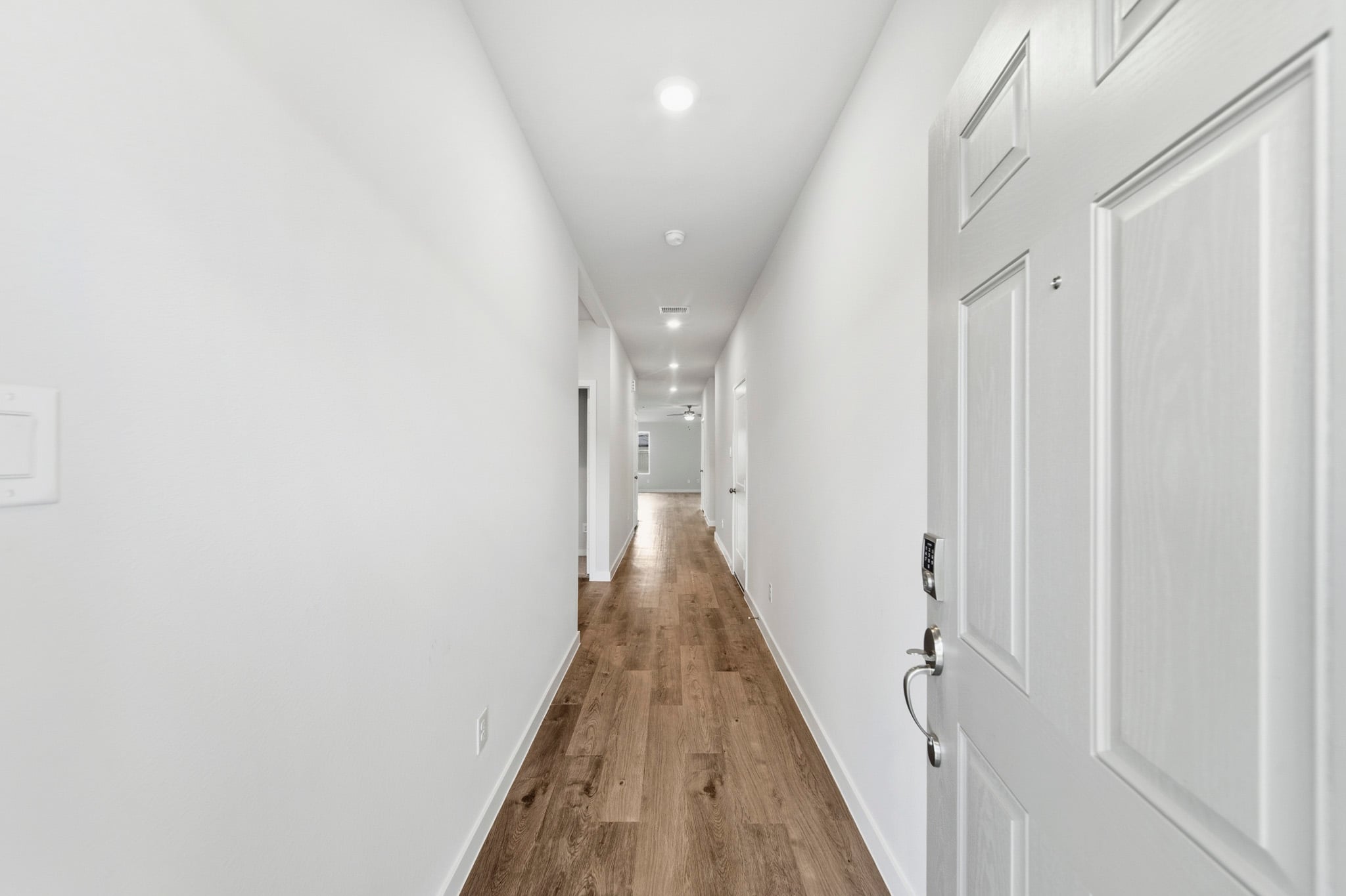 A hallway with white doors.