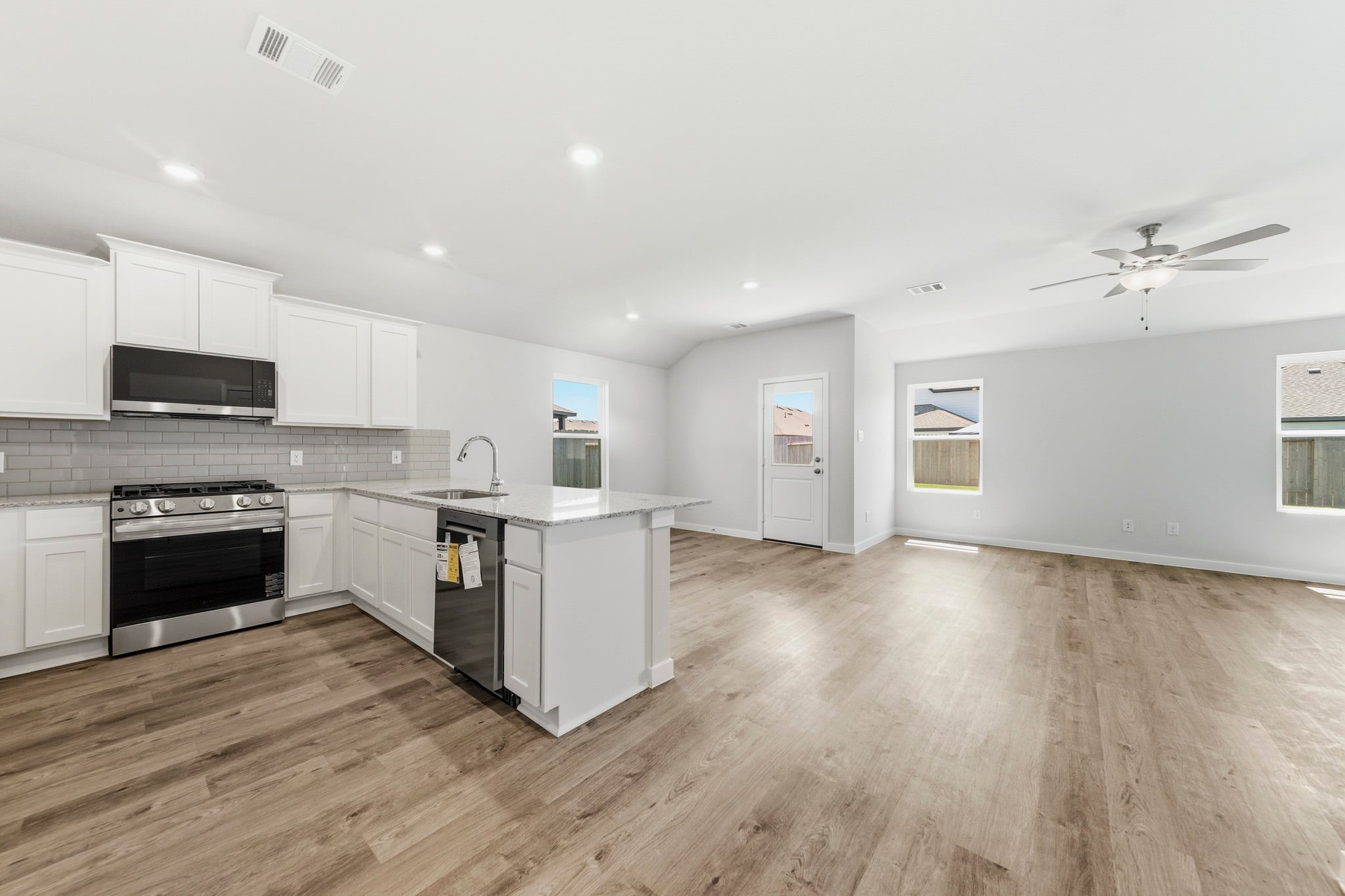 A kitchen with white cabinets.