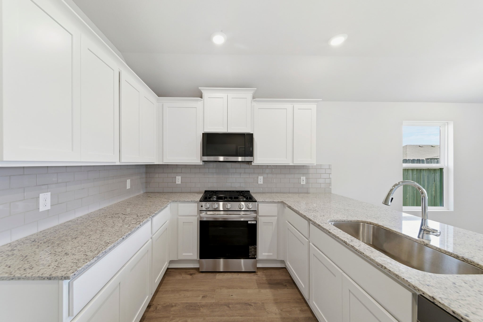 A kitchen with white cabinets.