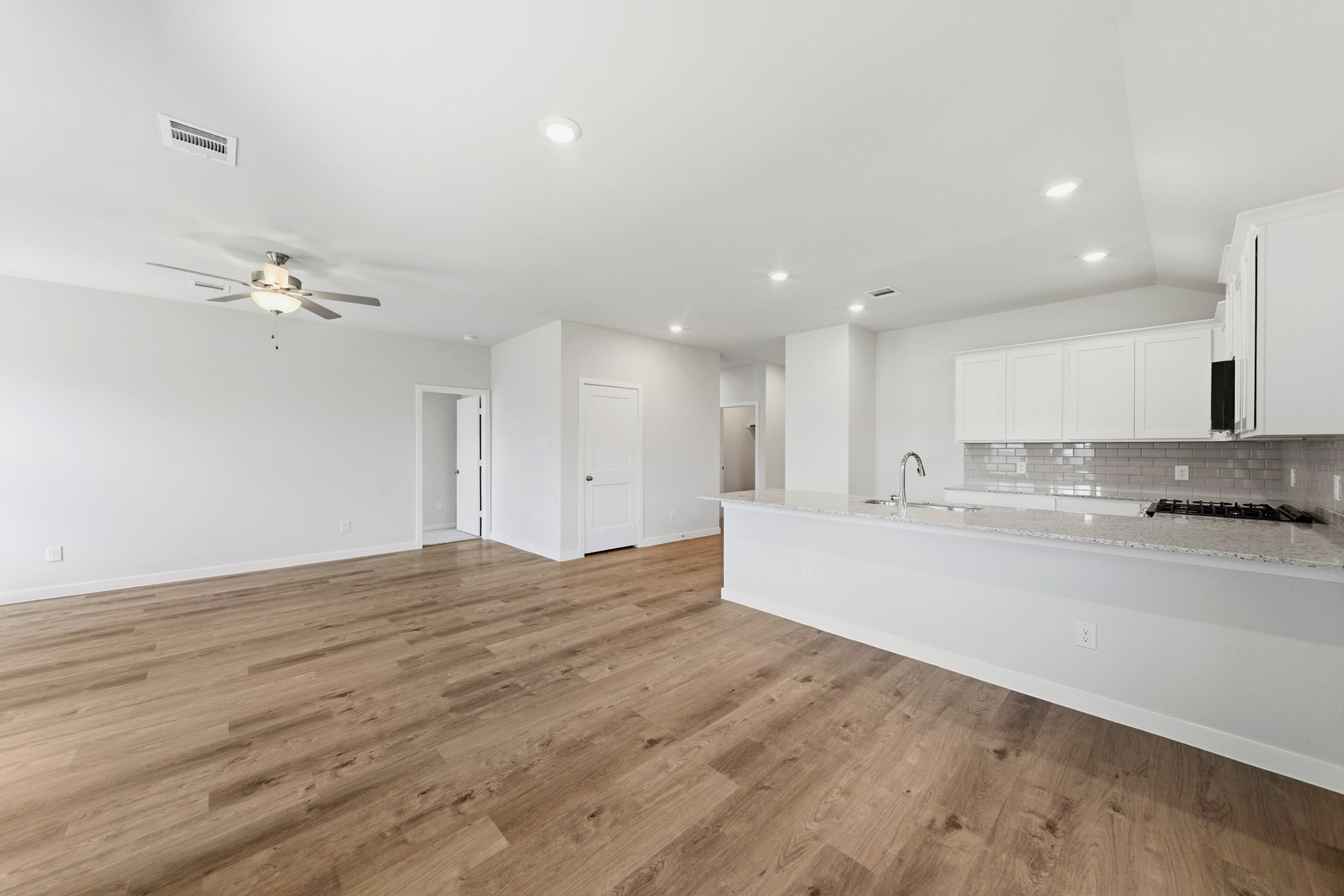 A large kitchen with white cabinets.