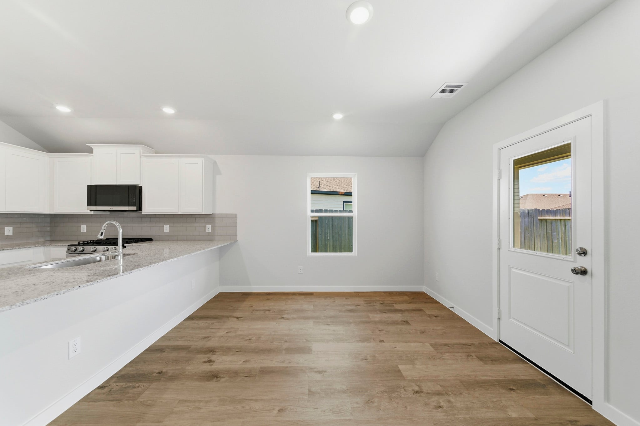 A kitchen with white cabinets.