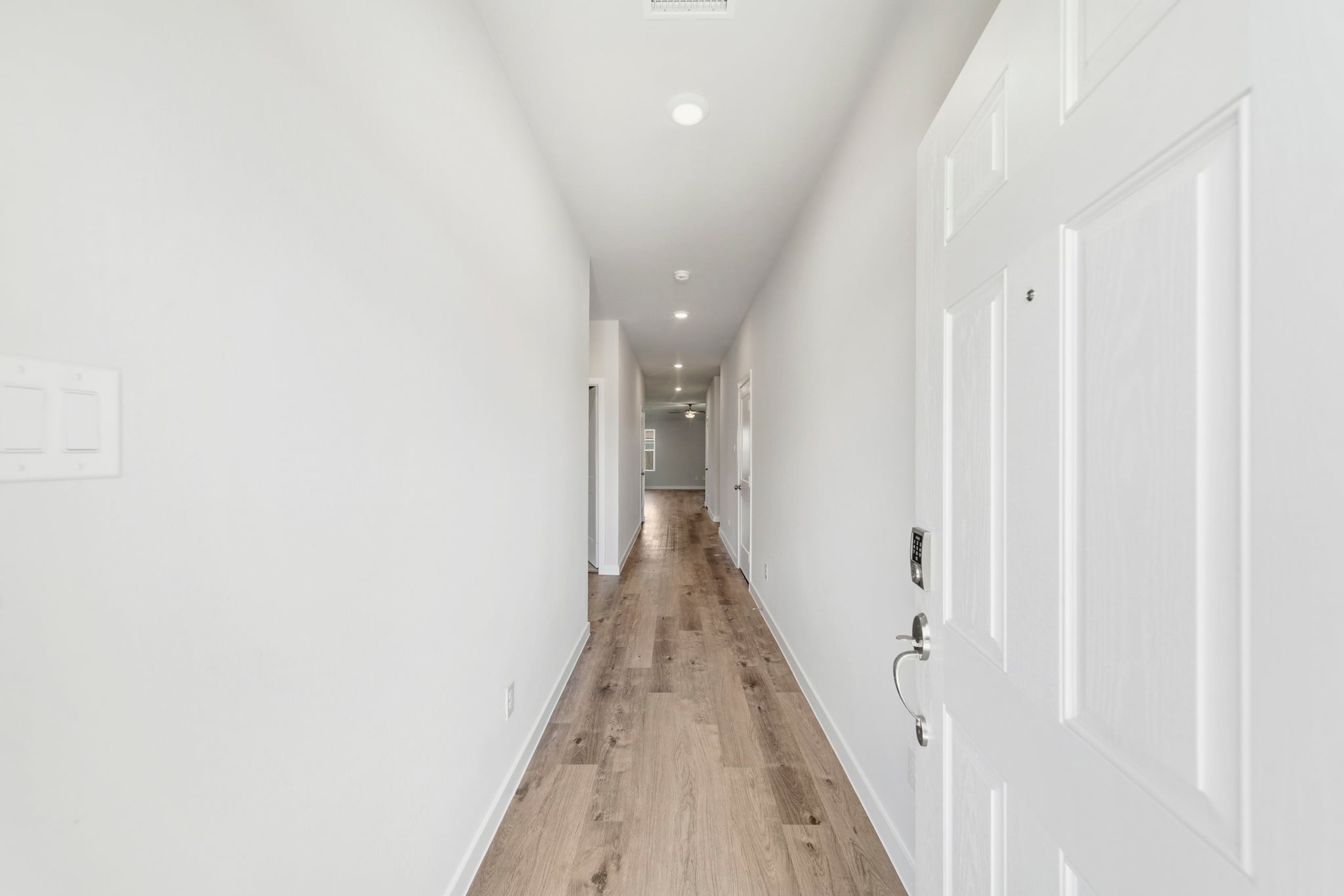 A hallway with white doors.