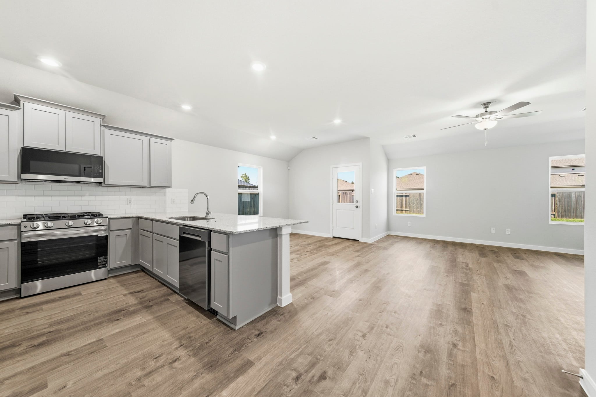 A kitchen with white cabinets.