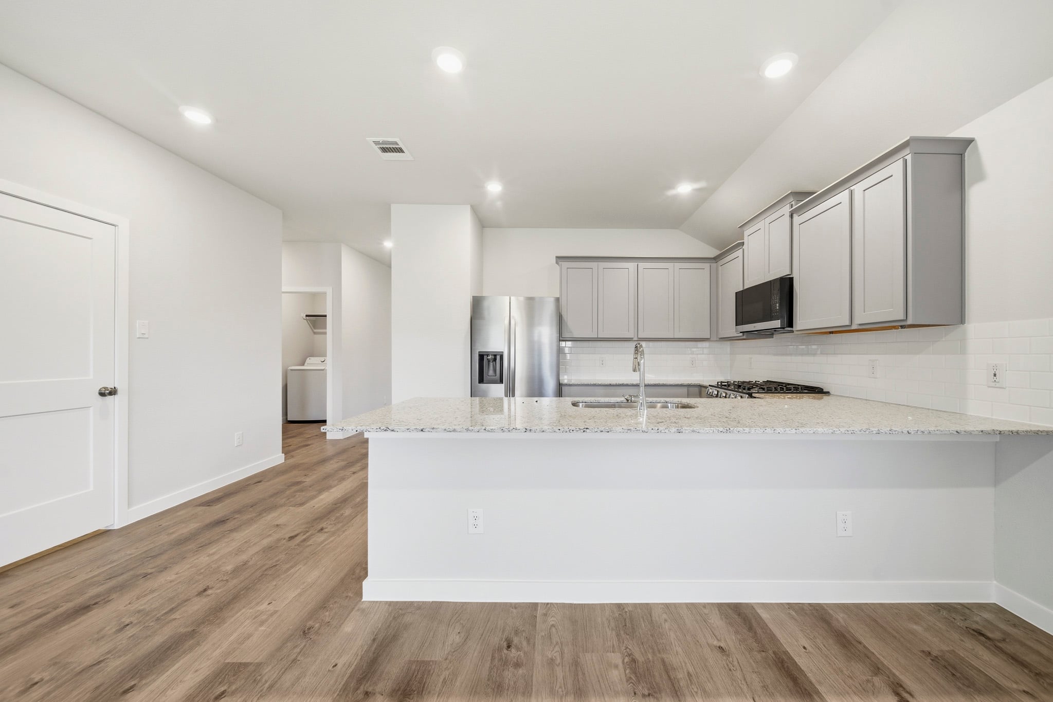 A kitchen with white cabinets.