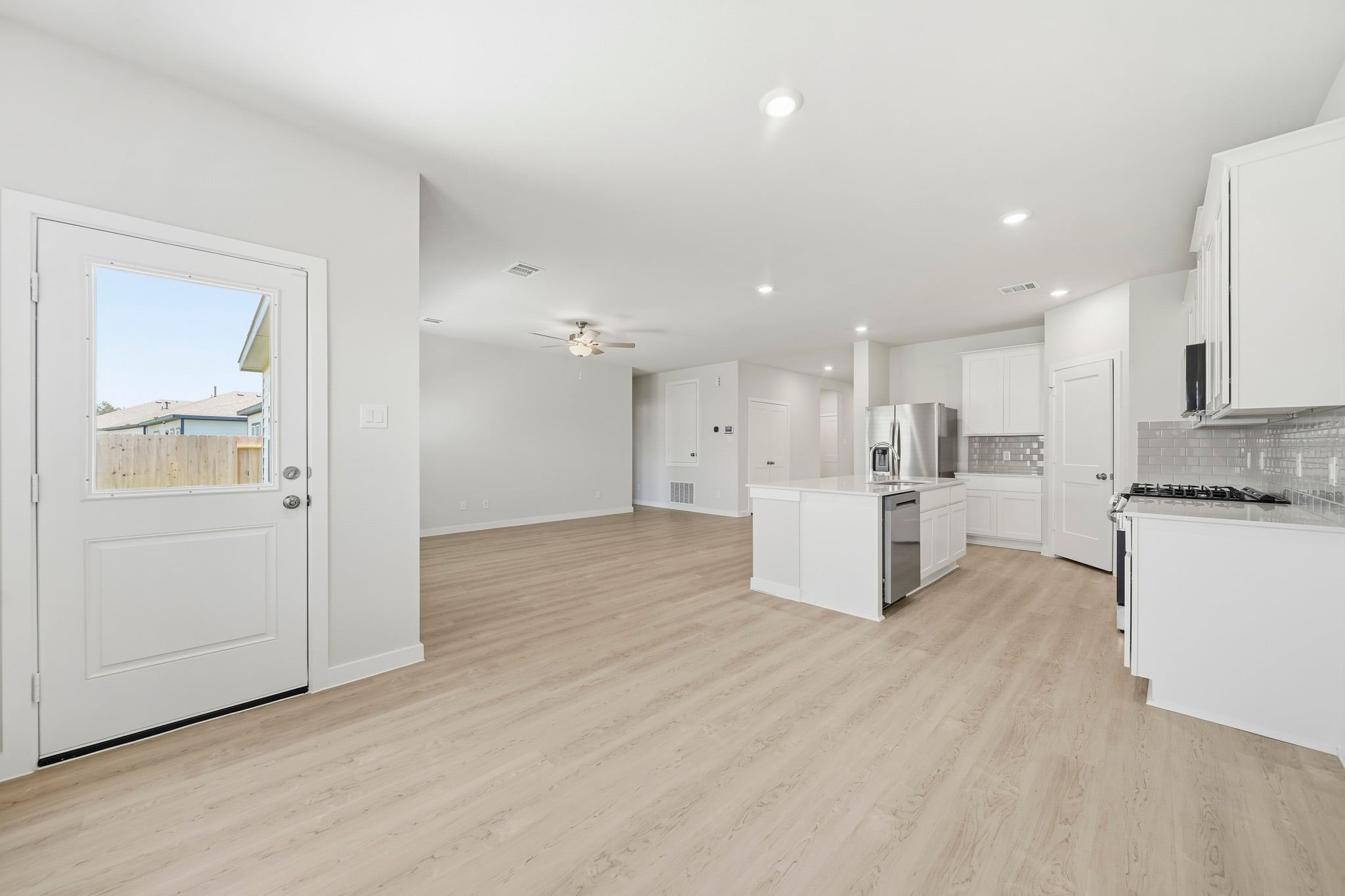 A large kitchen with white cabinets.