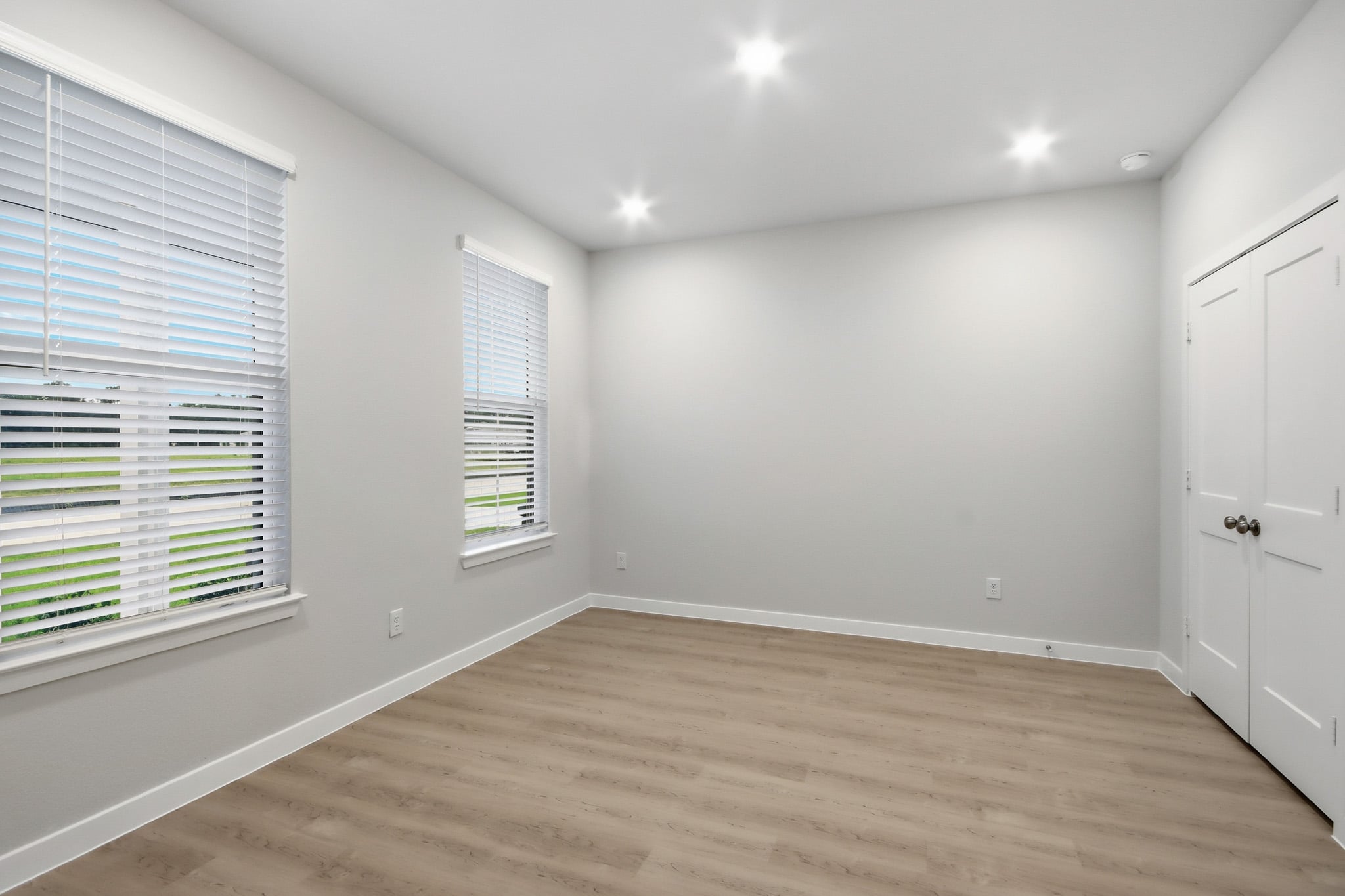 A room with a wood floor and white walls.