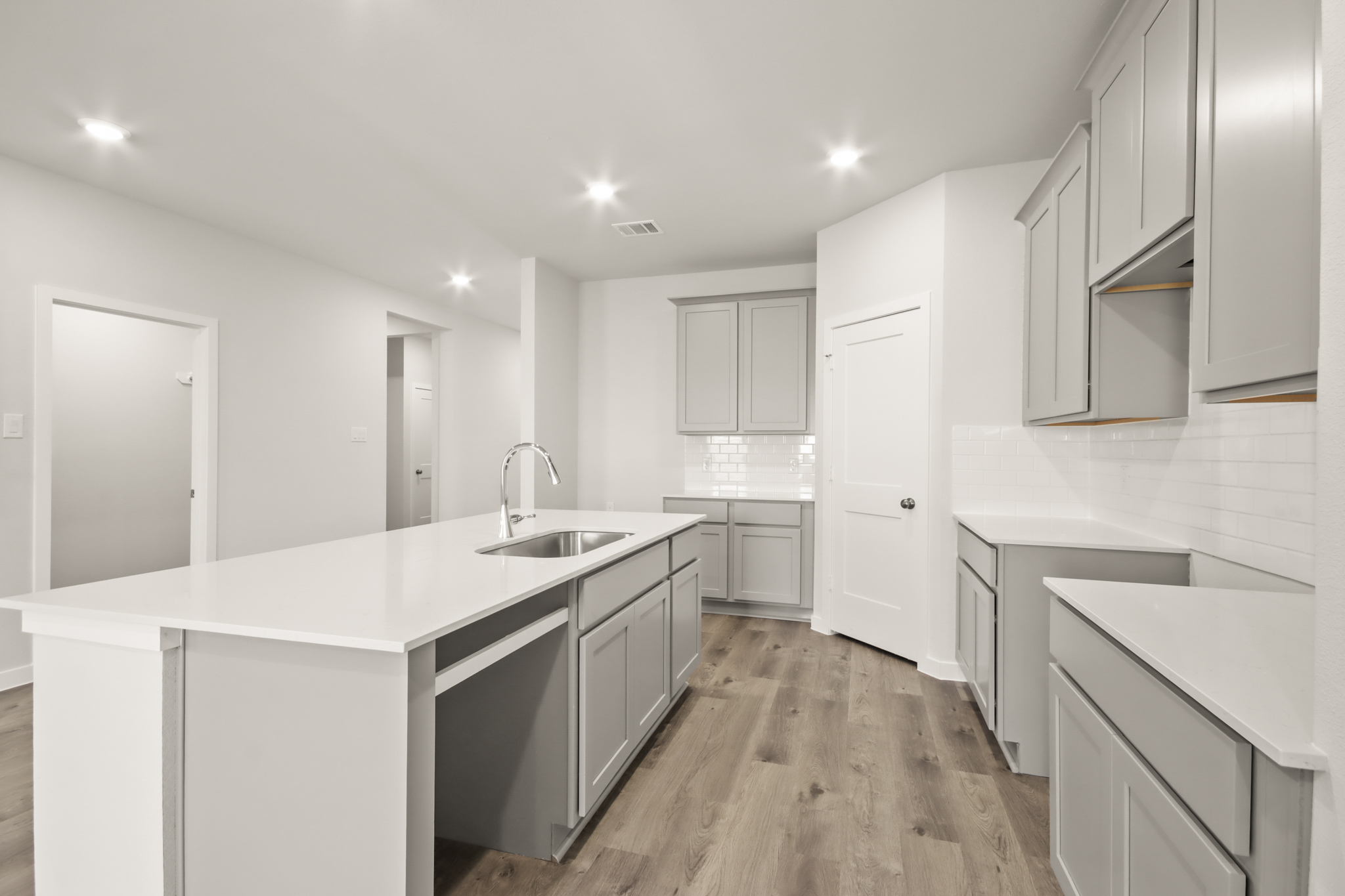 A kitchen with white cabinets.