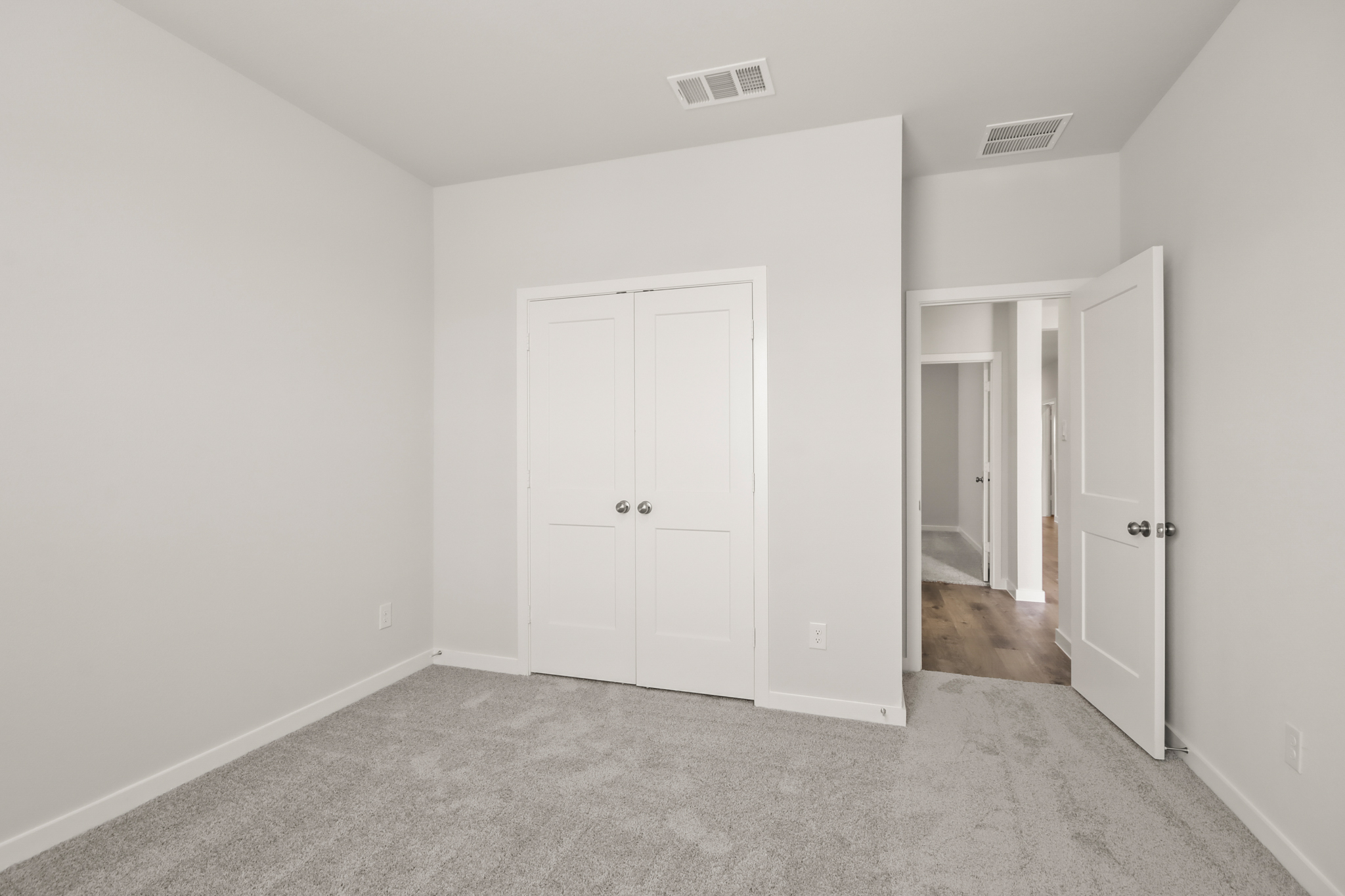 A hallway with white doors.