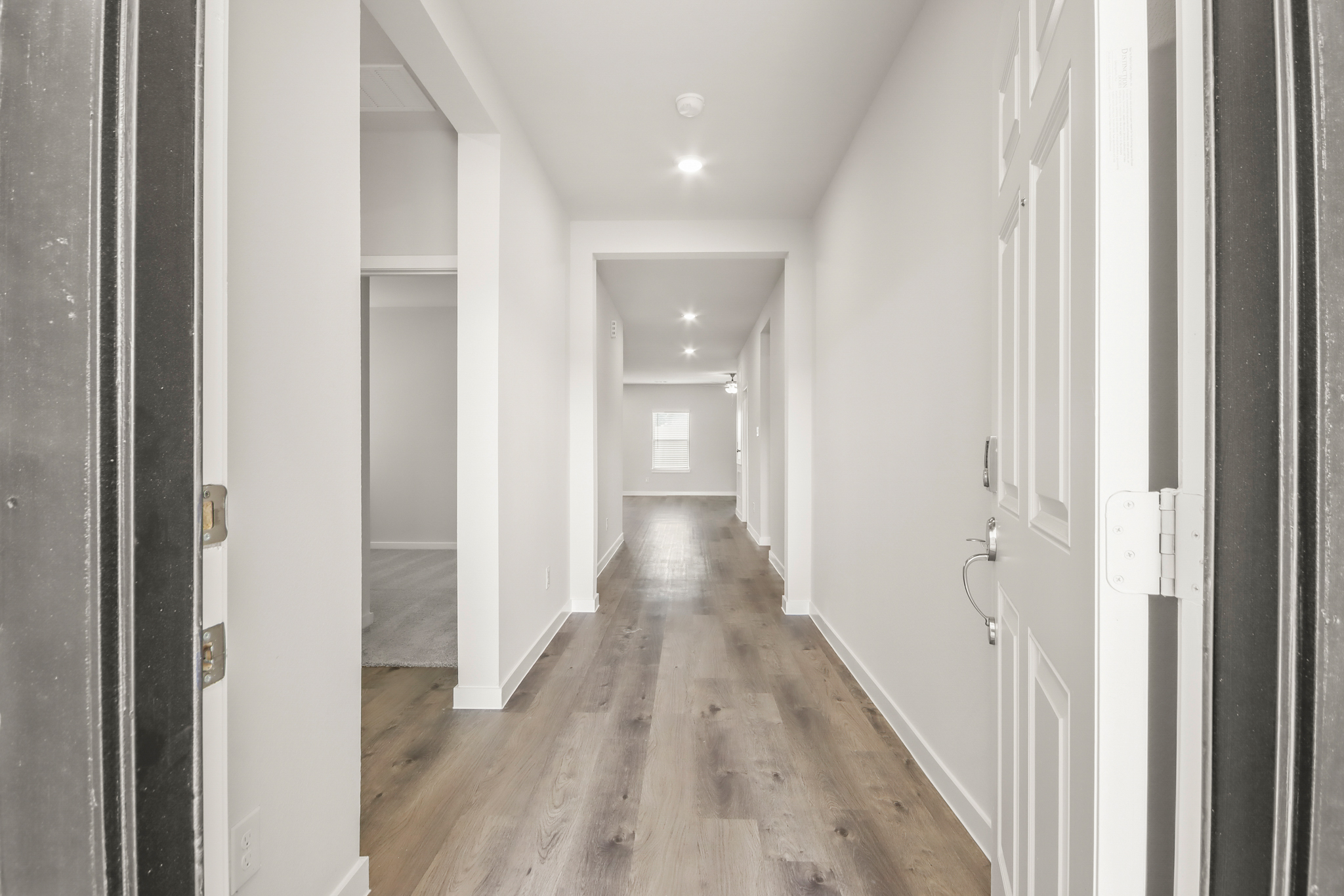 A hallway with white walls.