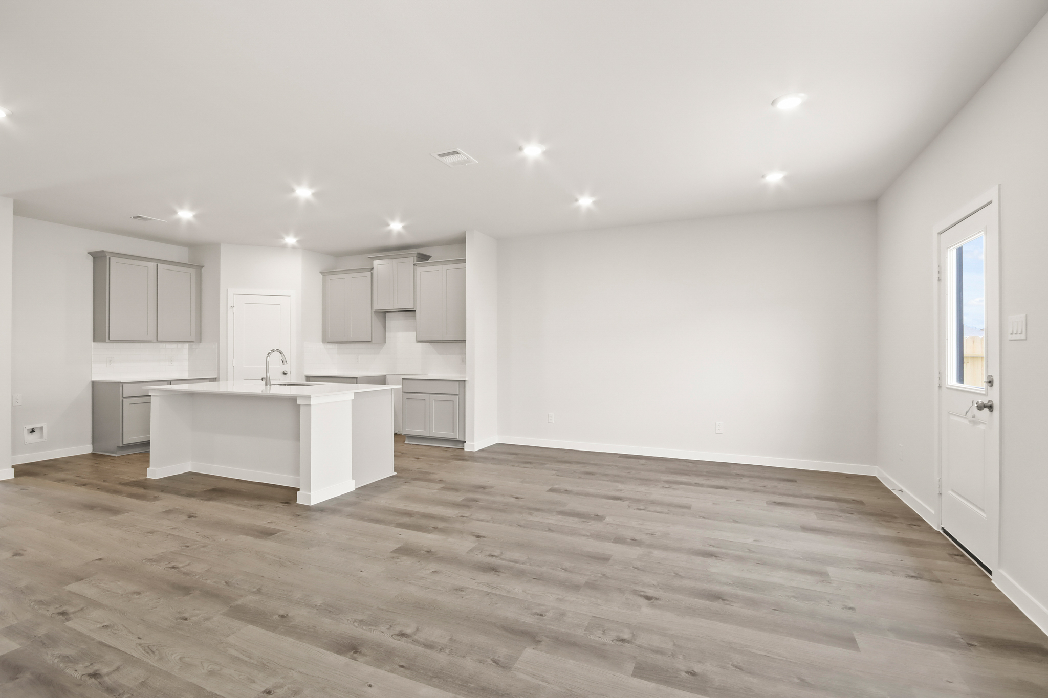 A kitchen with white cabinets.