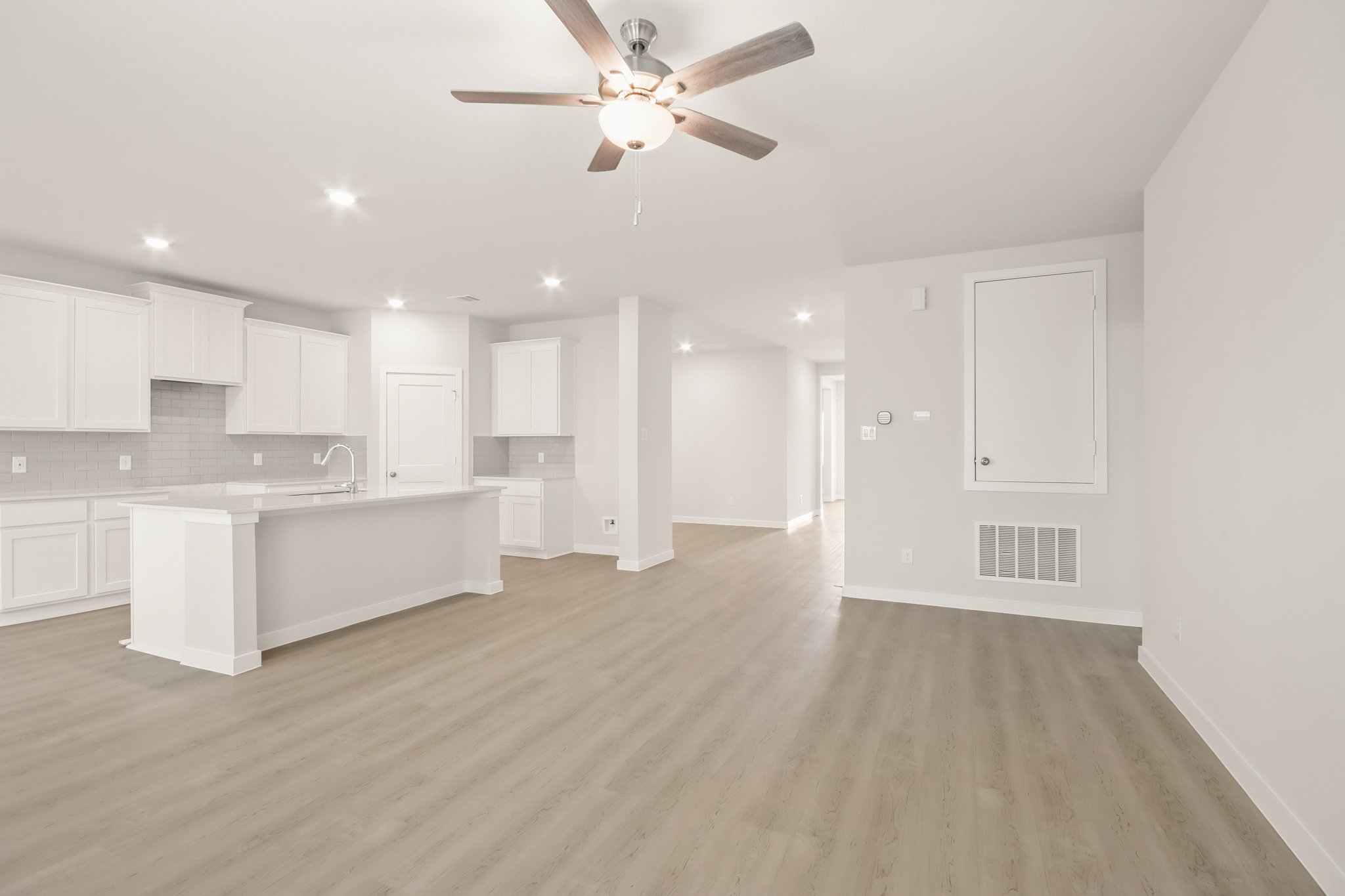 A kitchen with white cabinets.