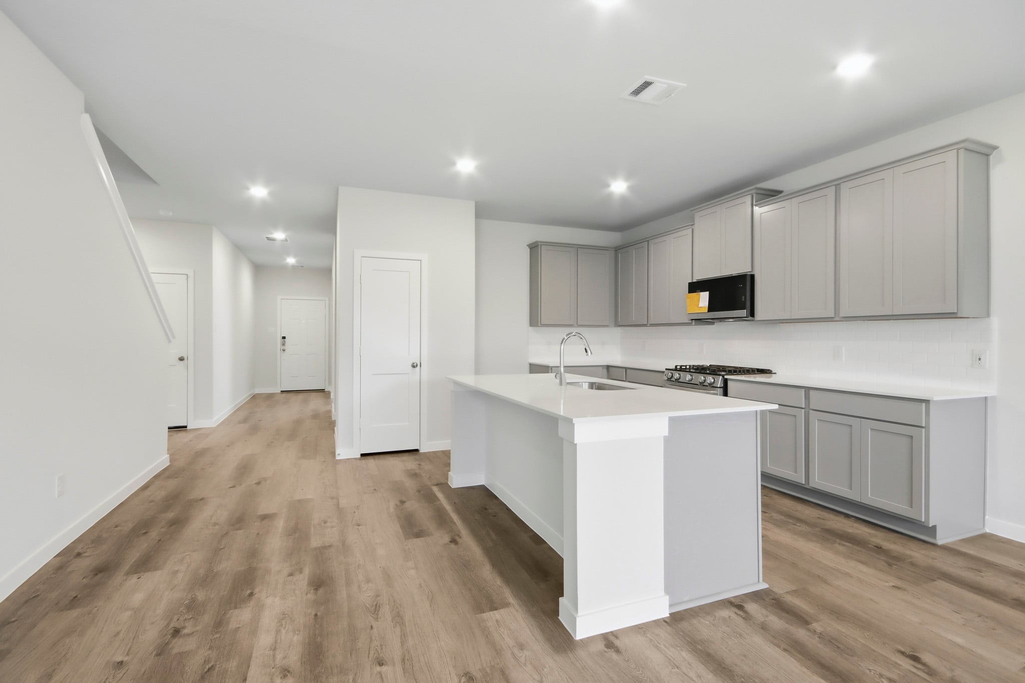 A kitchen with white cabinets.