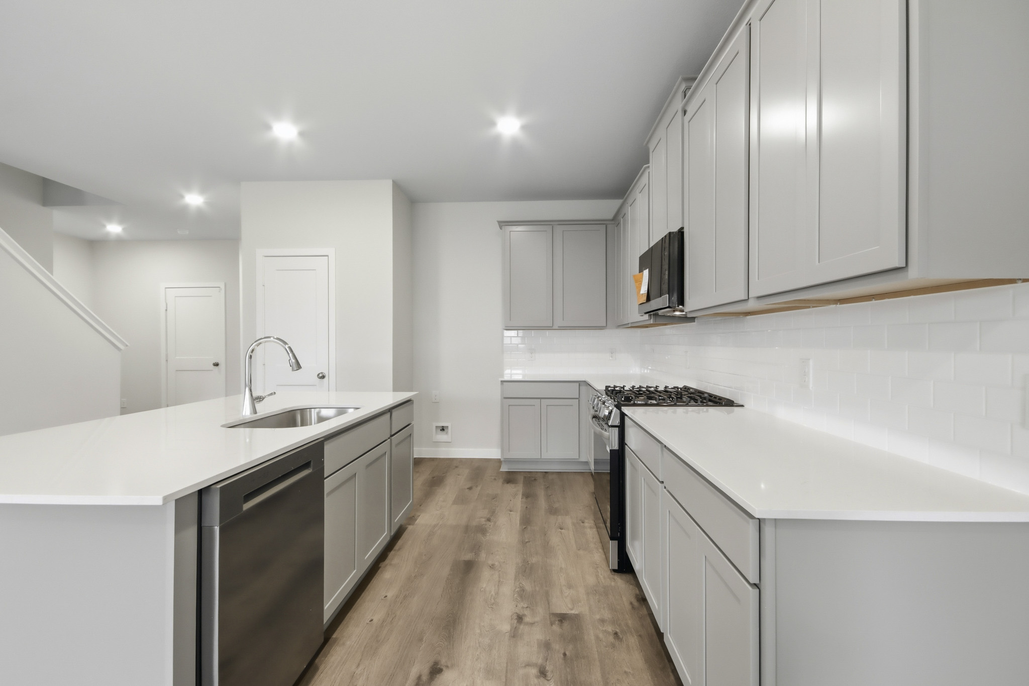 A kitchen with white cabinets.