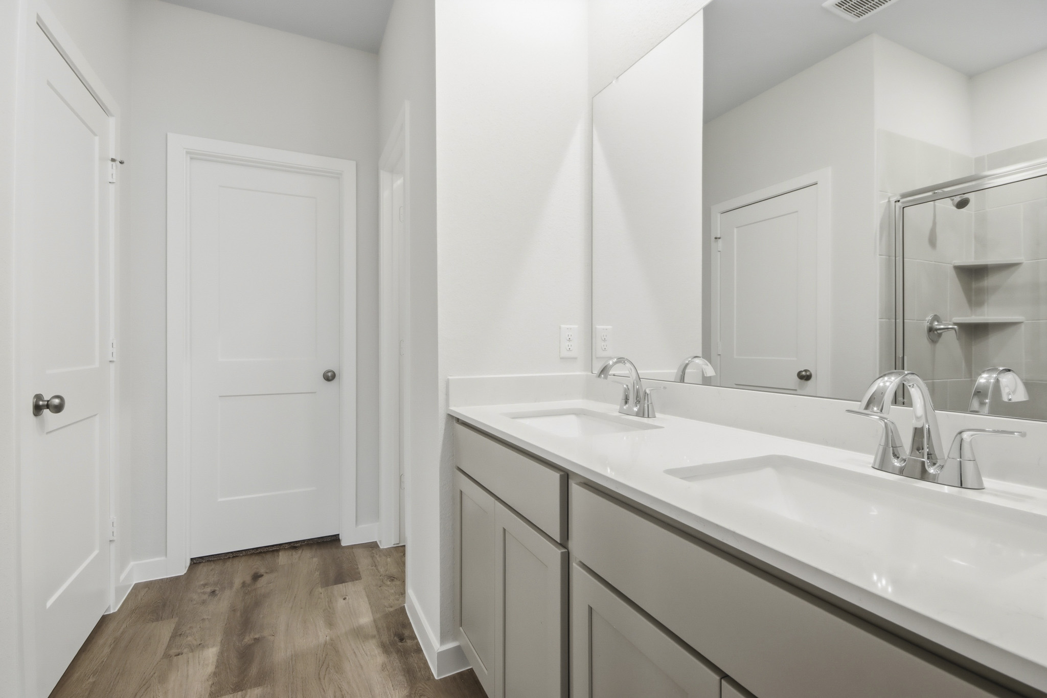A bathroom with a large mirror.