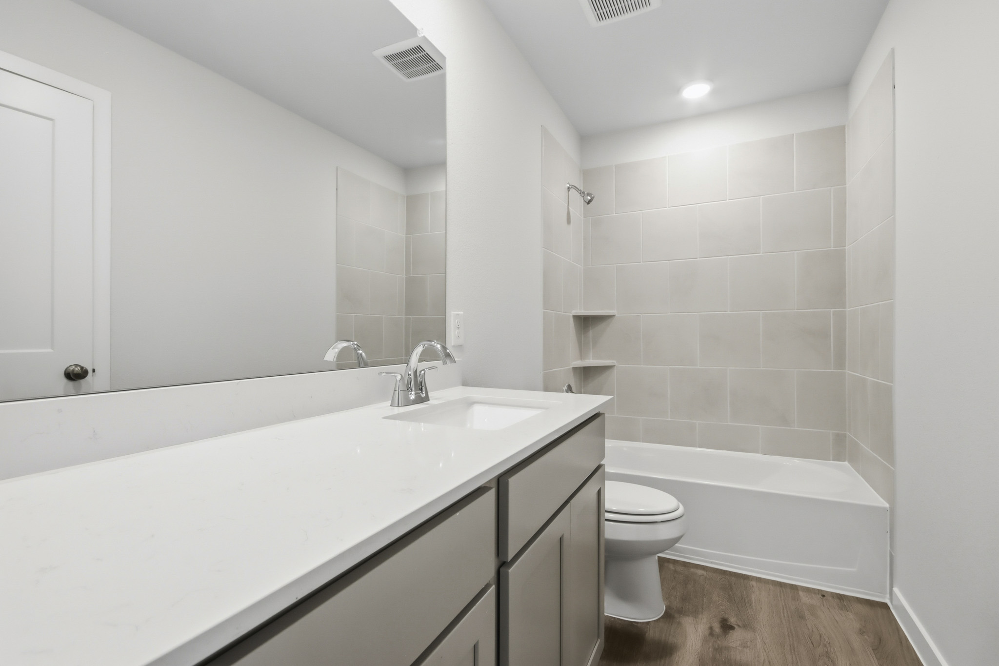 A bathroom with a tub sink and toilet.
