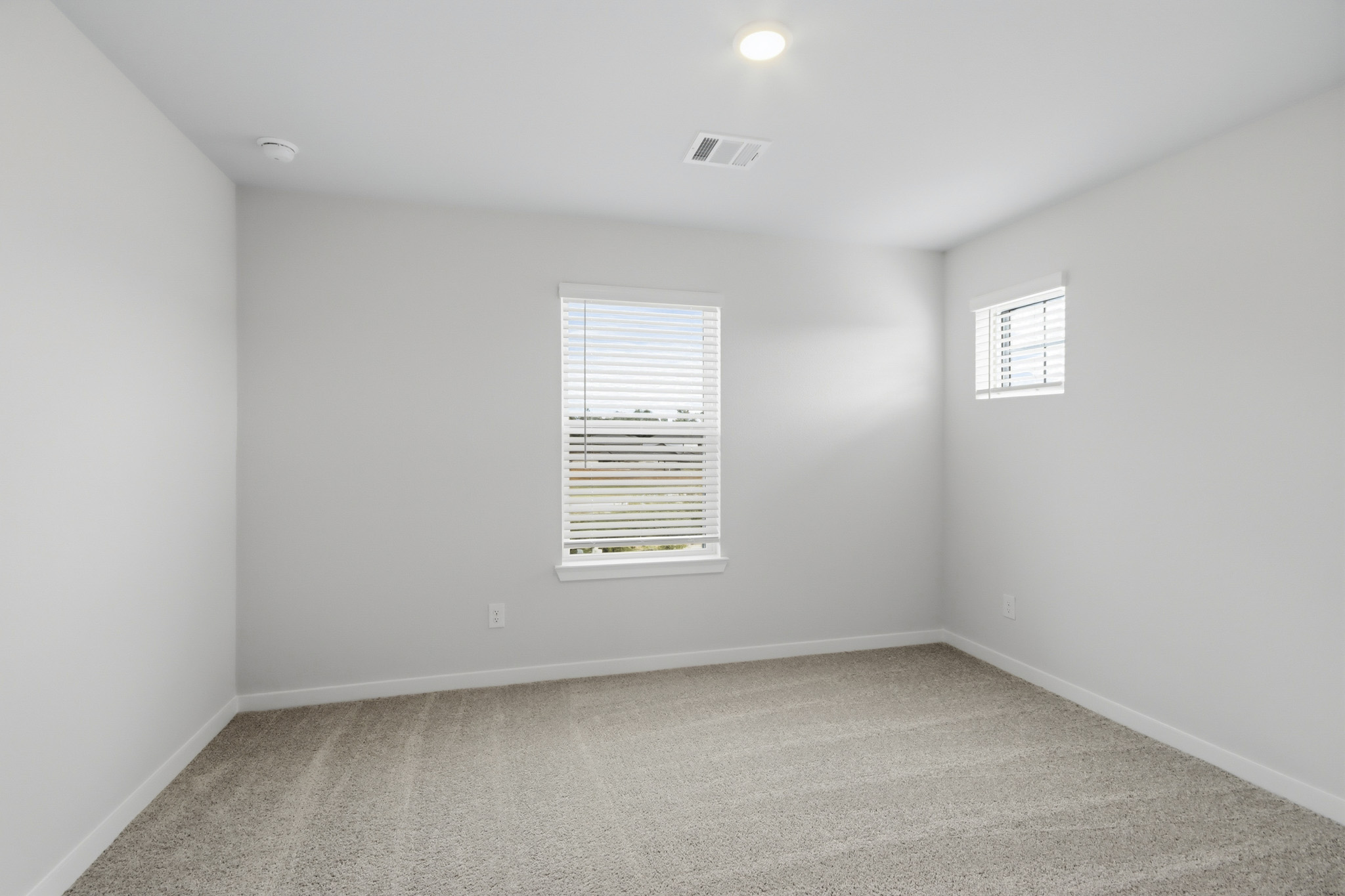 A room with a window and a carpet.