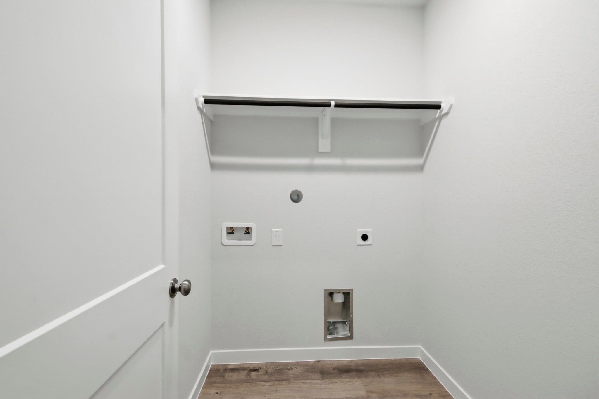A white wall with a light fixture.