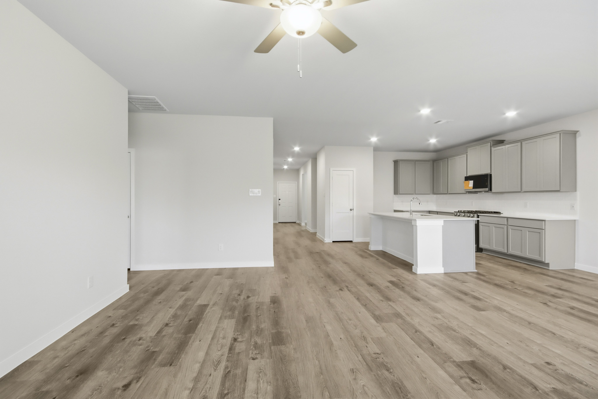 A large kitchen with white cabinets.