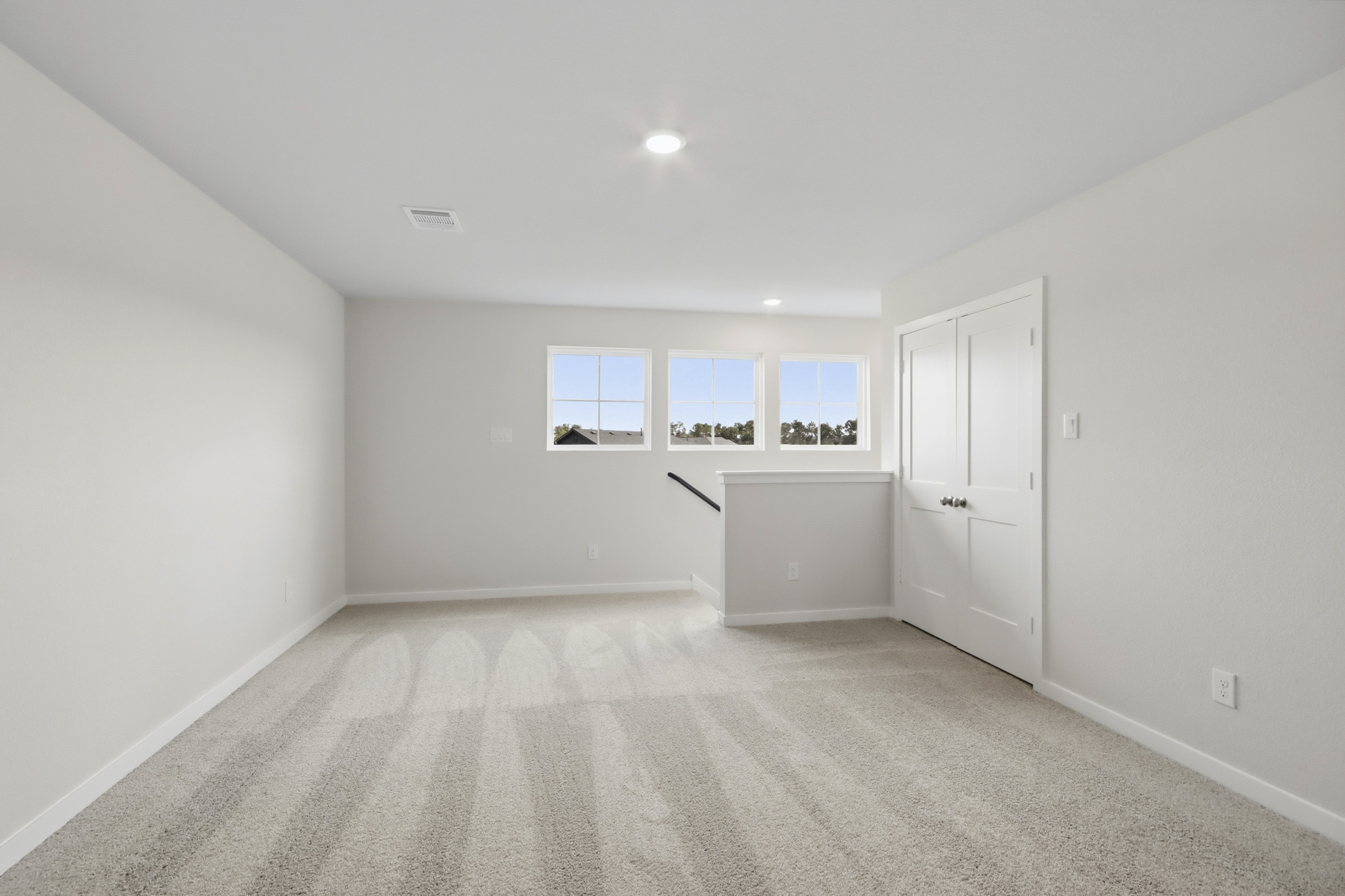 A room with white walls and windows.