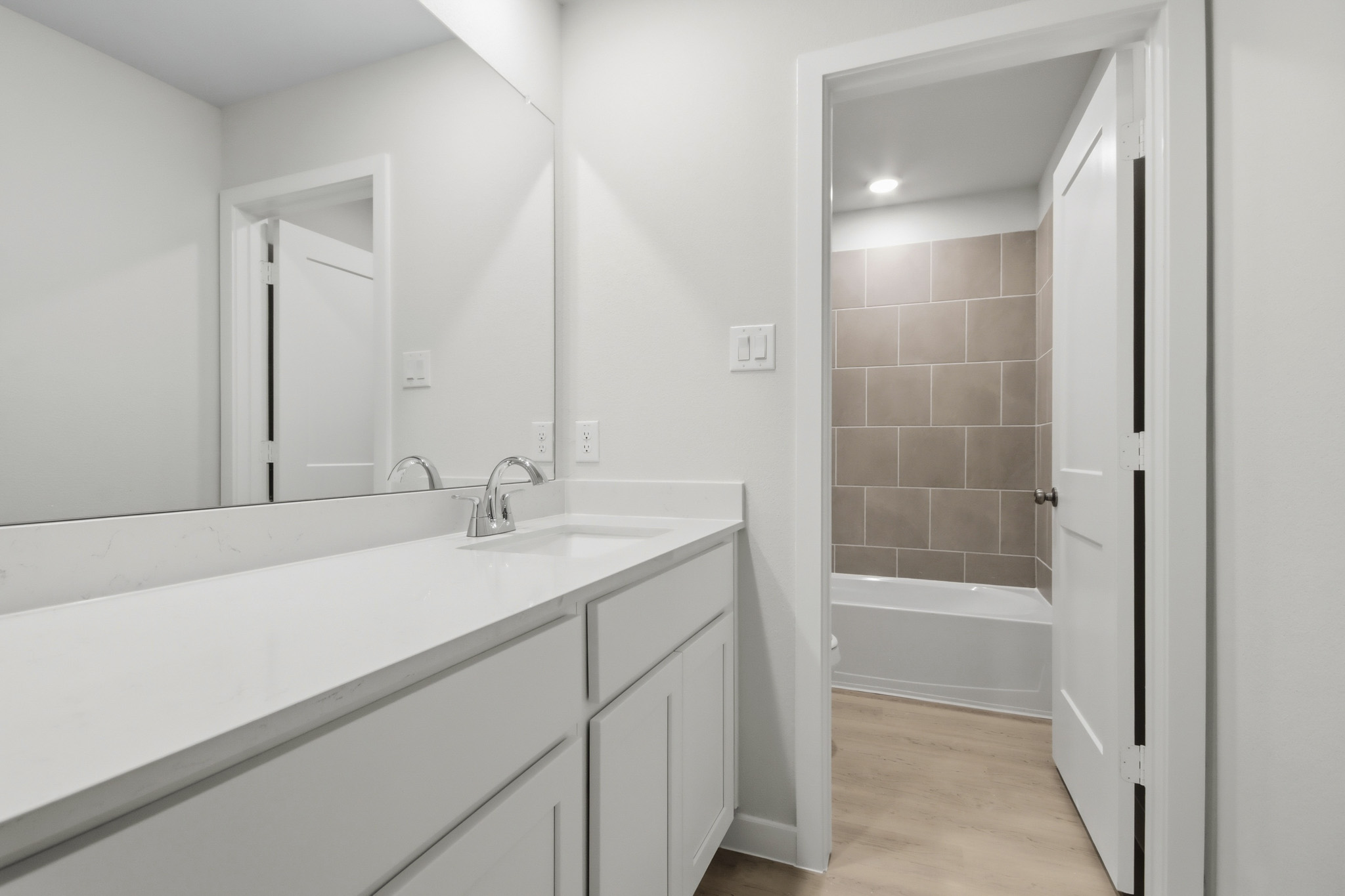 A bathroom with a tub sink and a bathtub.