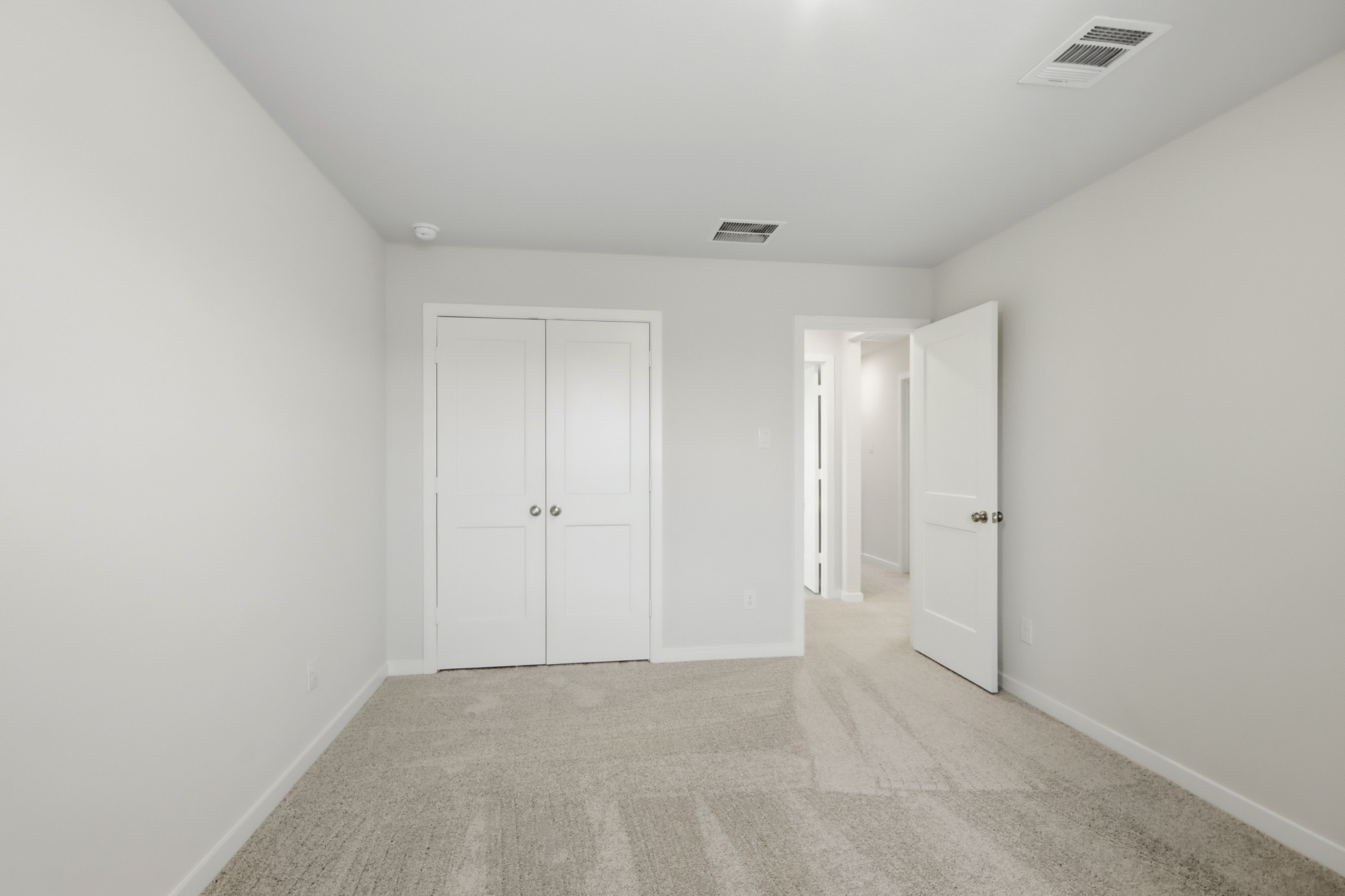 A hallway with white doors.