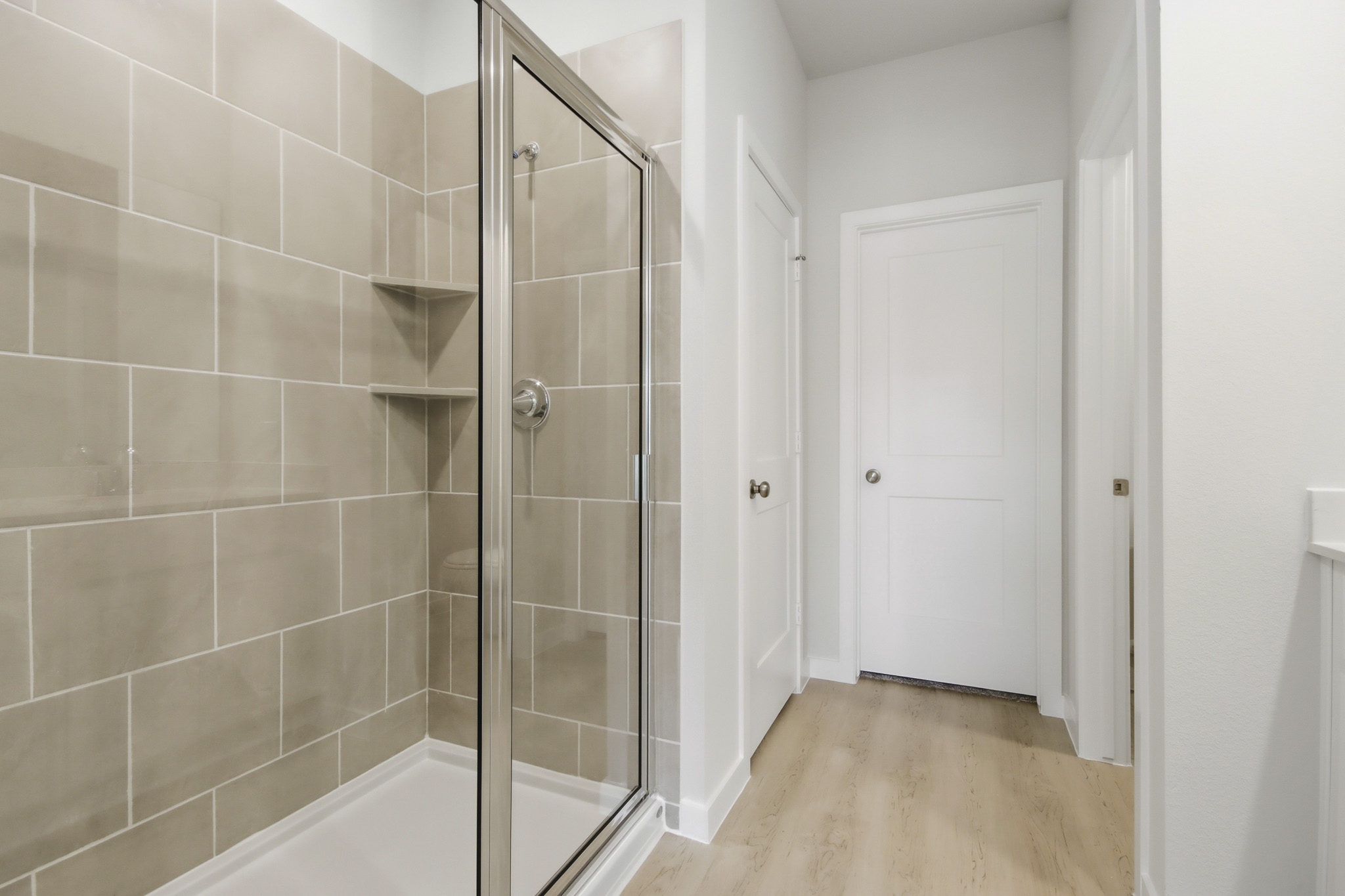 A shower with a glass door.