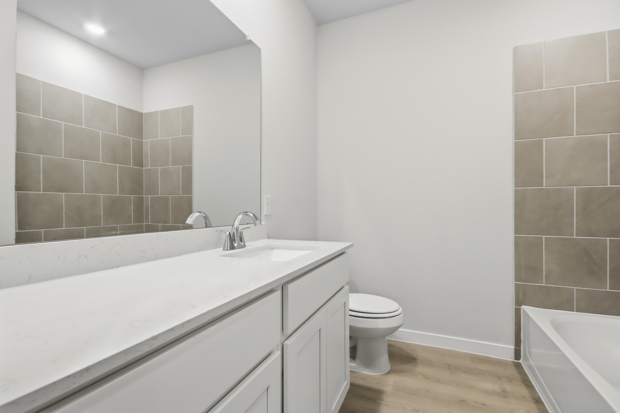 A bathroom with a tub toilet and sink.