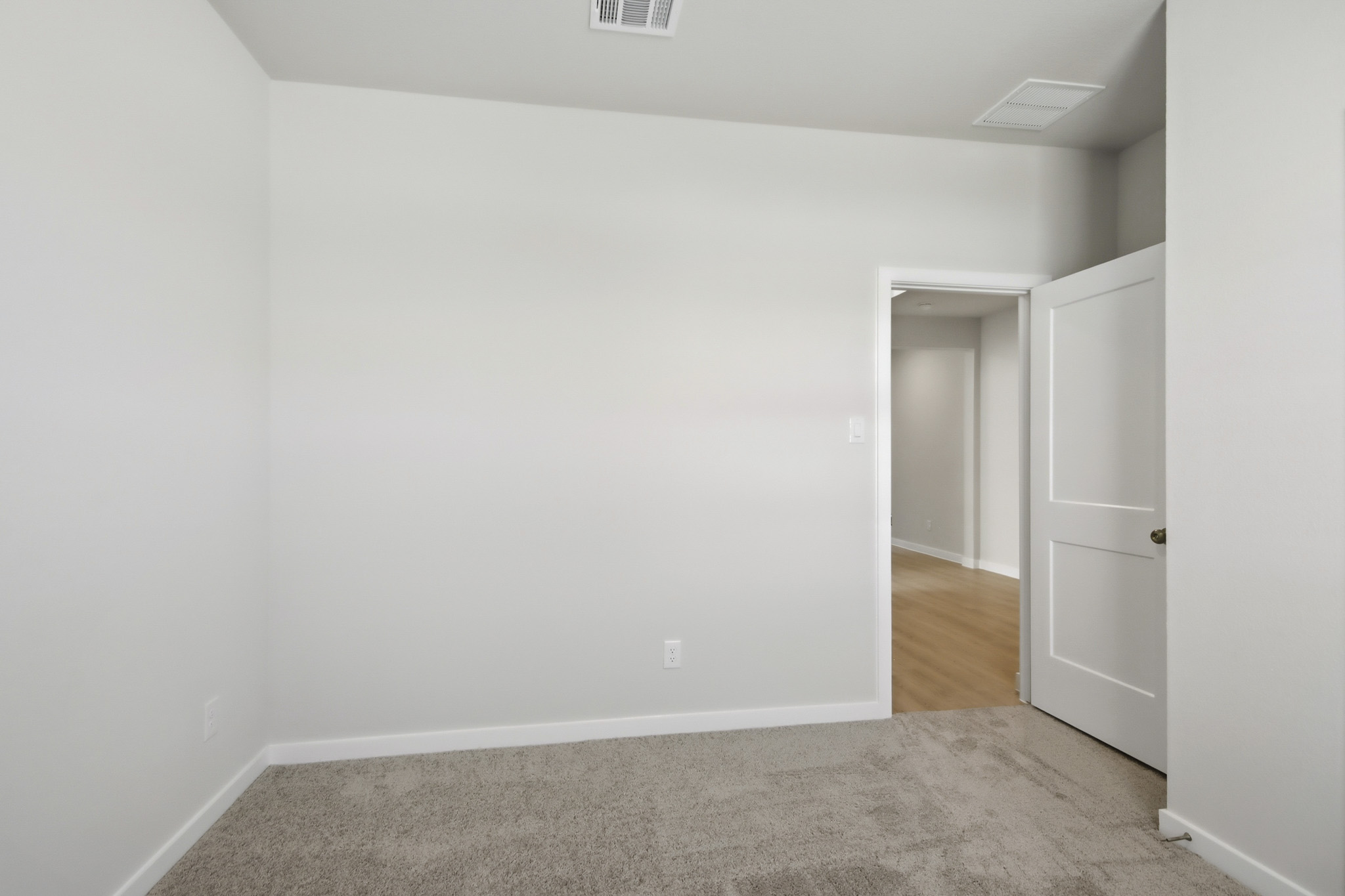 A hallway with white walls.