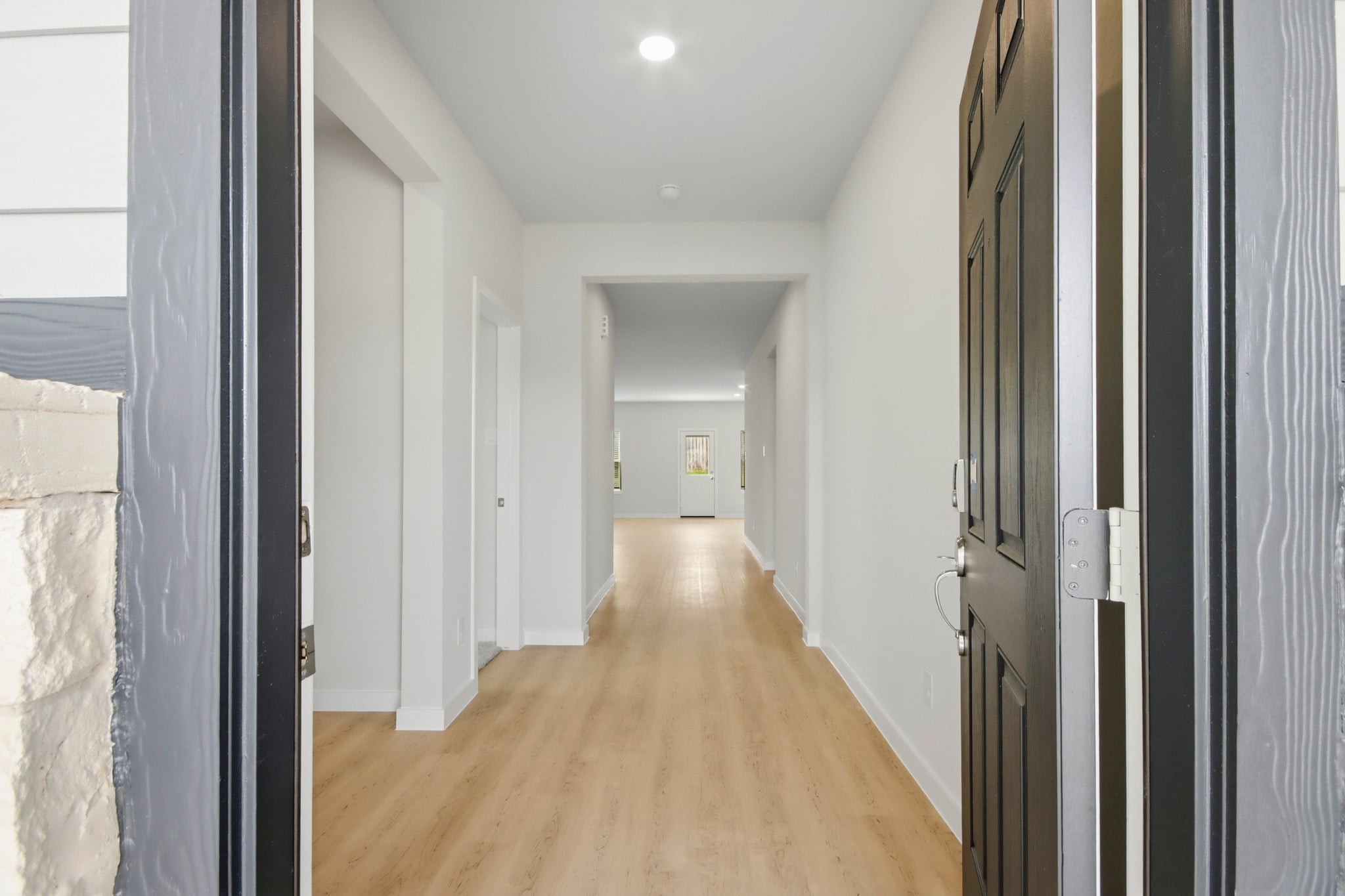 A long hallway with white walls.